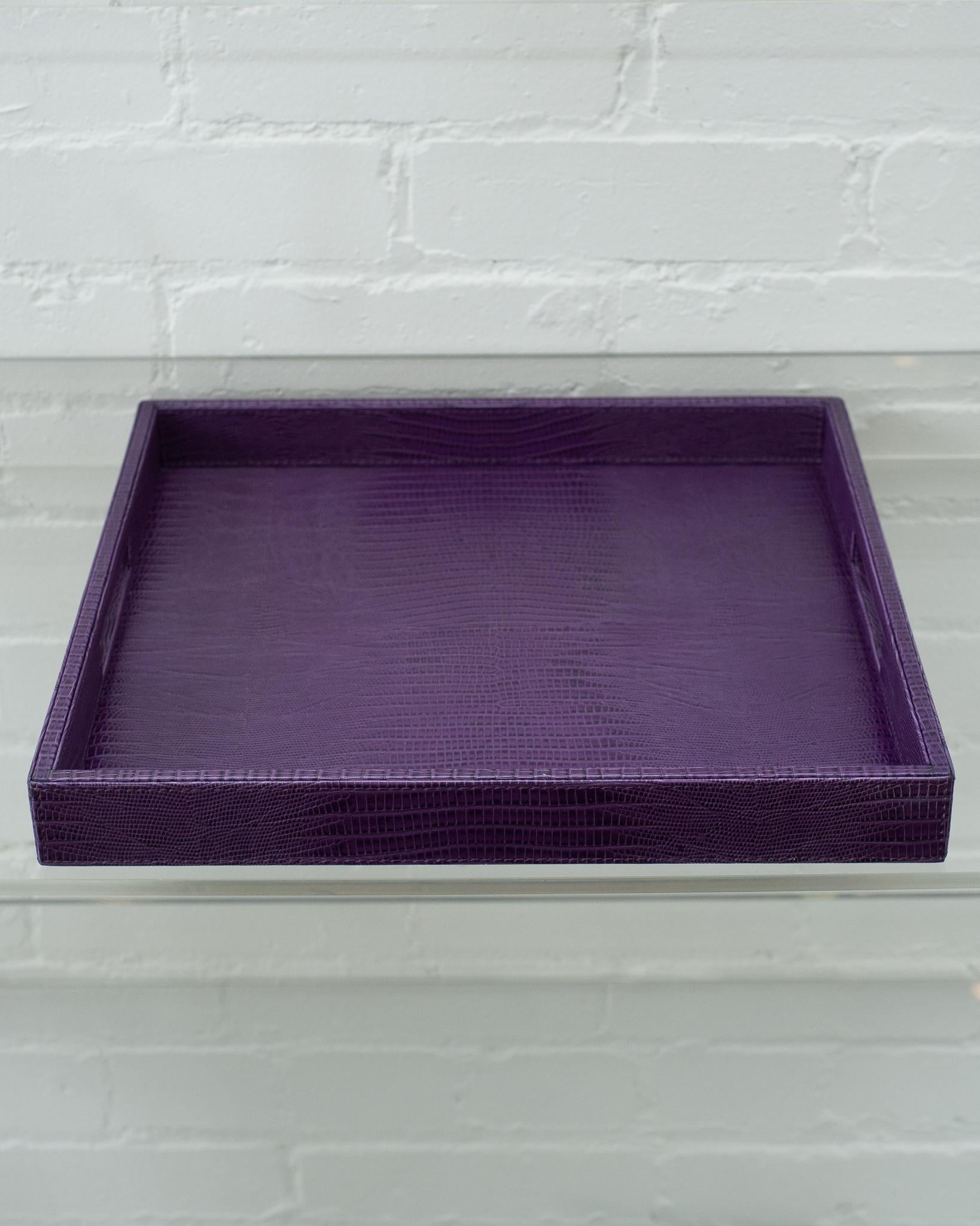 A beautiful purple lizard embossed leather tray, perfect for the desk, bedside table, or use as a serving piece. Fully wrapped in embossed leather with stitched panels, each tray has two openings for carrying.