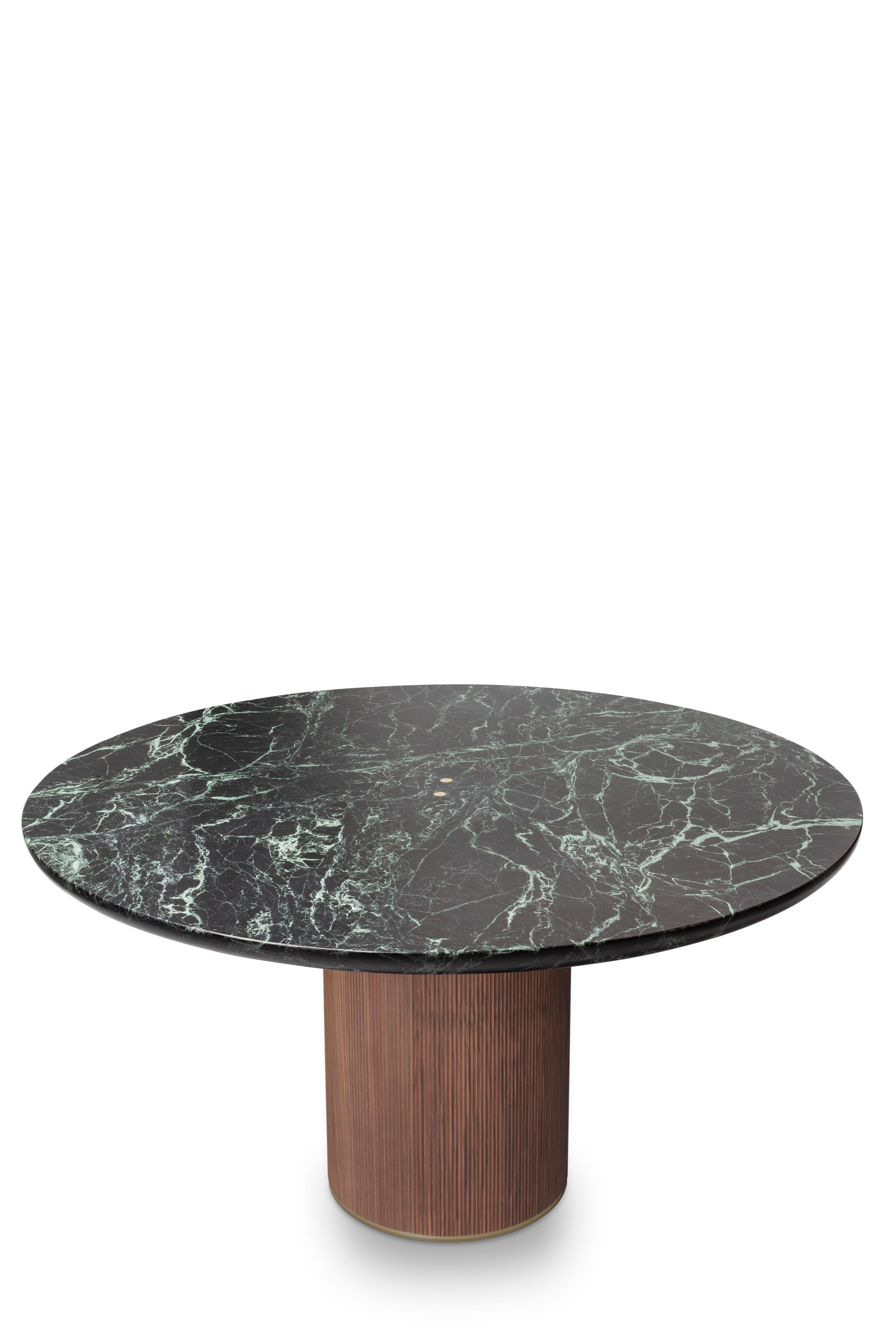 The QD05 dining table is made of green marble and a walnut wood base with beautiful details made in brass. Its elegant simplicity makes it adaptable to many spaces.

Please note that due to the current increase in raw material cost, prices must be