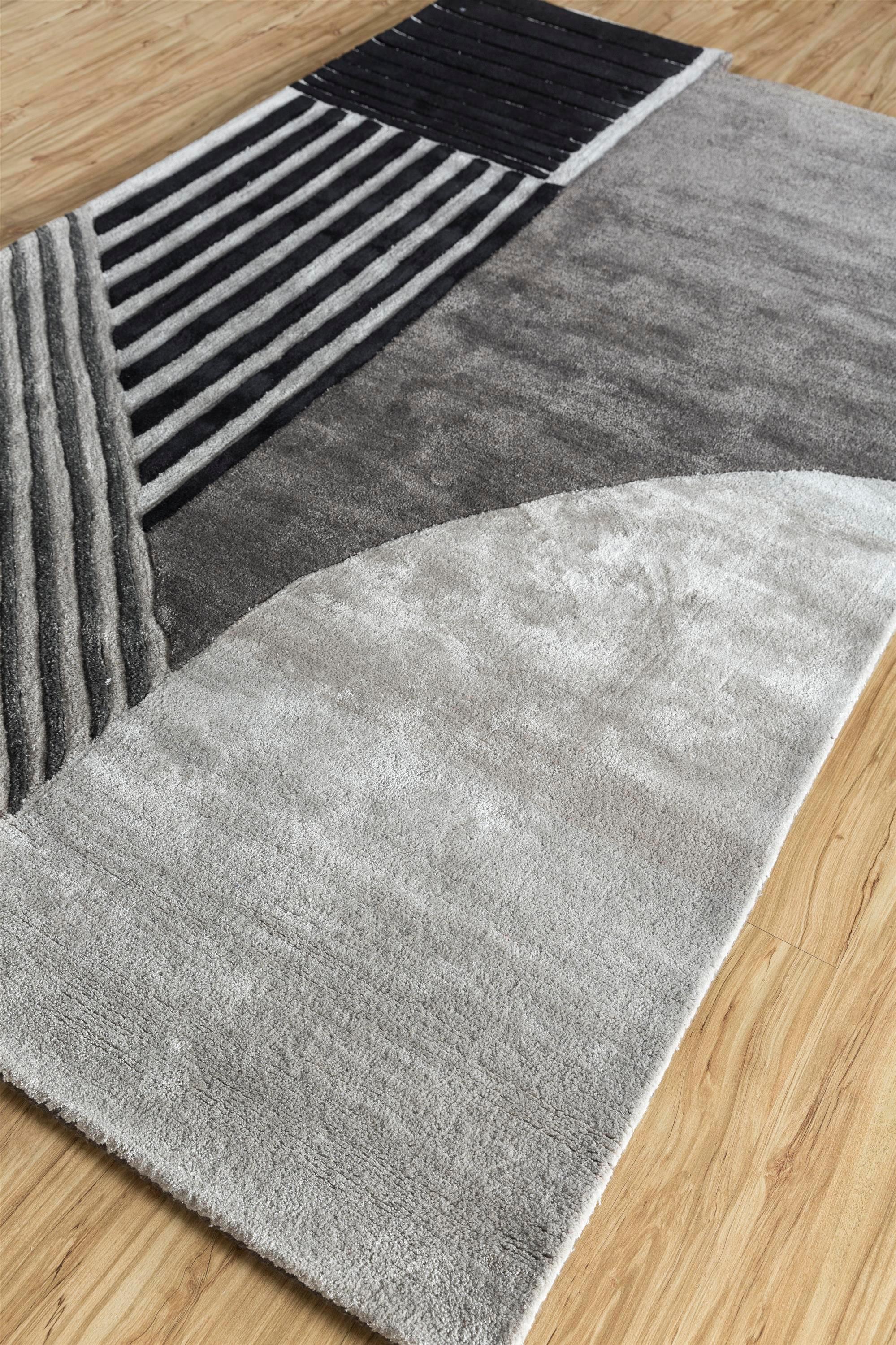 Have you ever wondered how art meets functionality? Dive into the realm of modern design with our Hand Tufted rug, skillfully handmade in rural India. This playful masterpiece unfolds like origami, a captivating fusion of soft geometry and joyful