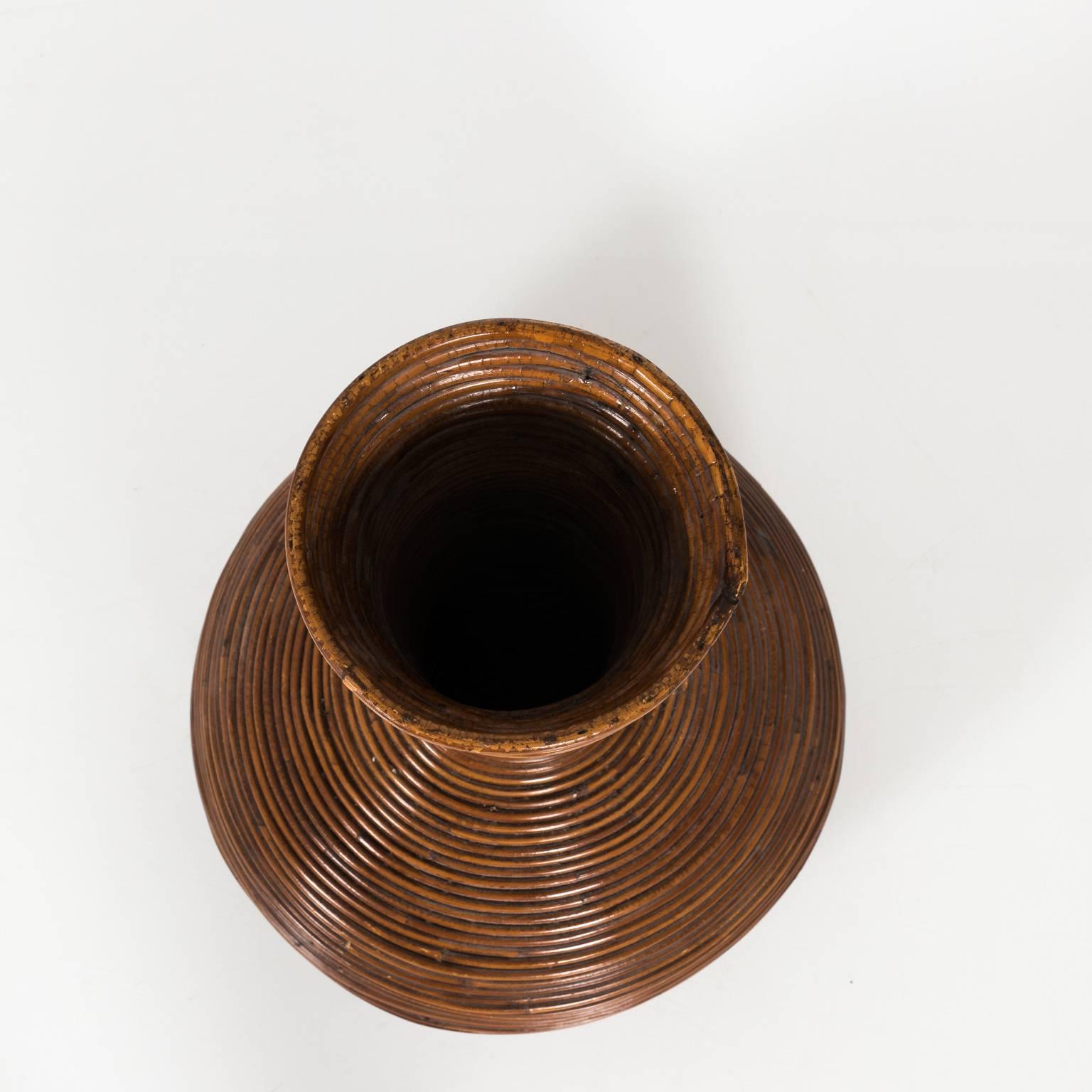 Contemporary brown rattan wrapped vase.
 
