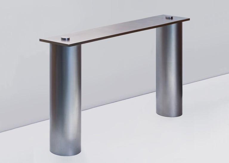 From a research centred on the role of style within design, the RC01 console consists of three pieces displaying an extreme formal and structural reduction. 

Two steel tubes are forming the base of the console onto which a marble plate is
