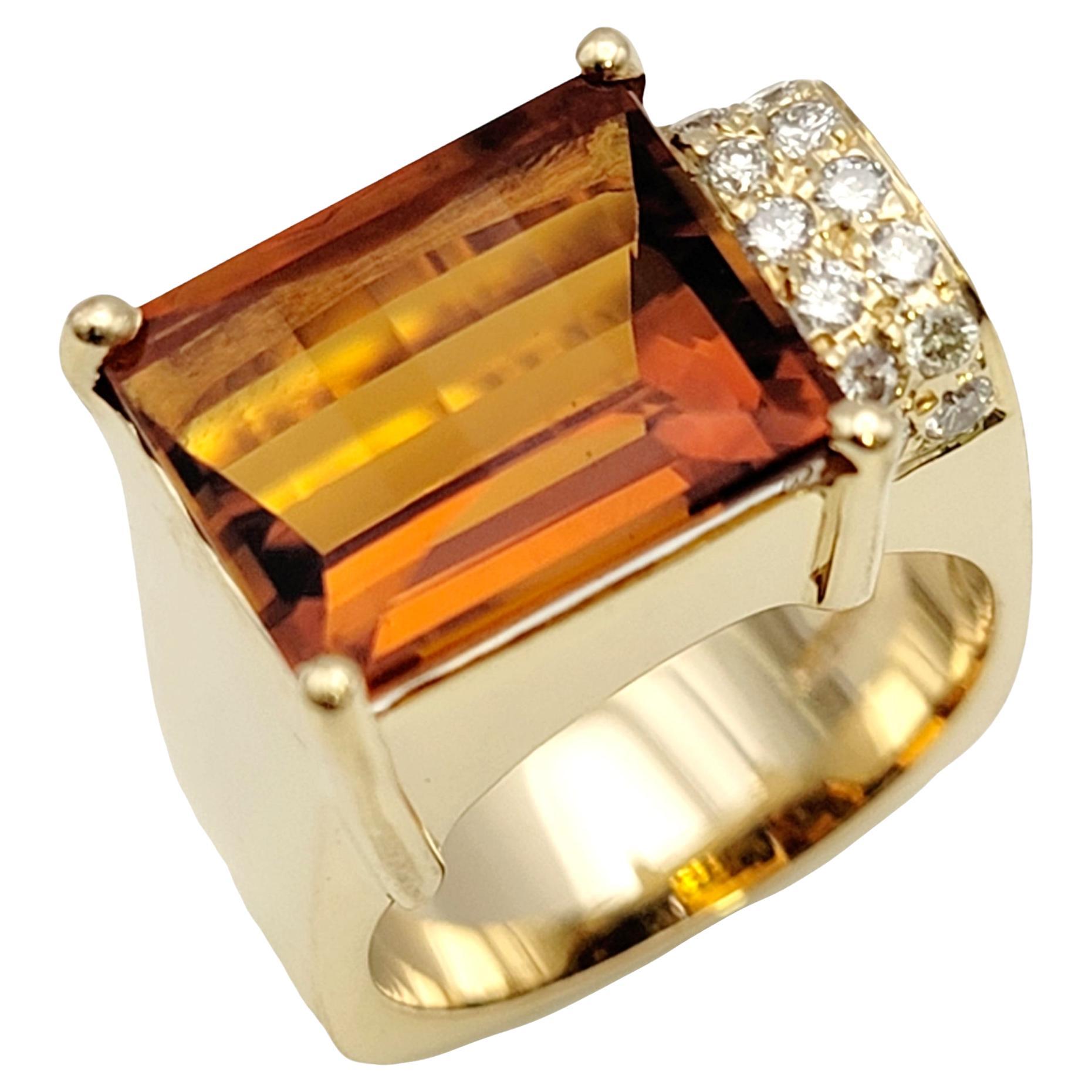 Ring size: 6.5

Gorgeous contemporary citrine and pave diamond ring. The rectangular cut vibrant orange citrine is prong set in a horizontal layout, filling the finger with sparkle. Set off to one side of the orange gemstone are two small rows of