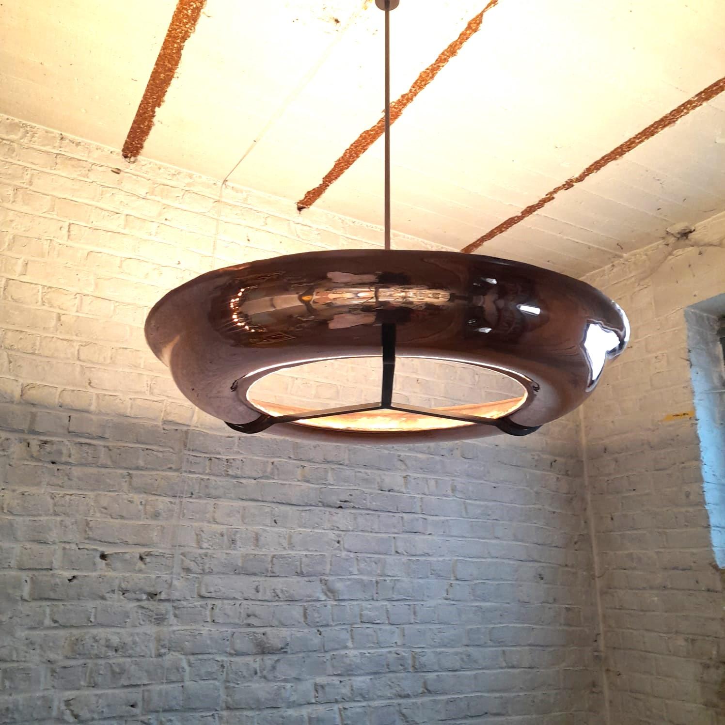 Pendant in red copper in ring form, with flexible led tubes, power supply can be either on distance or in the ring itself or in the canopy.
Overall height can be chosen according to height of ceiling. 
uplighter. 
Also available in yellow copper.