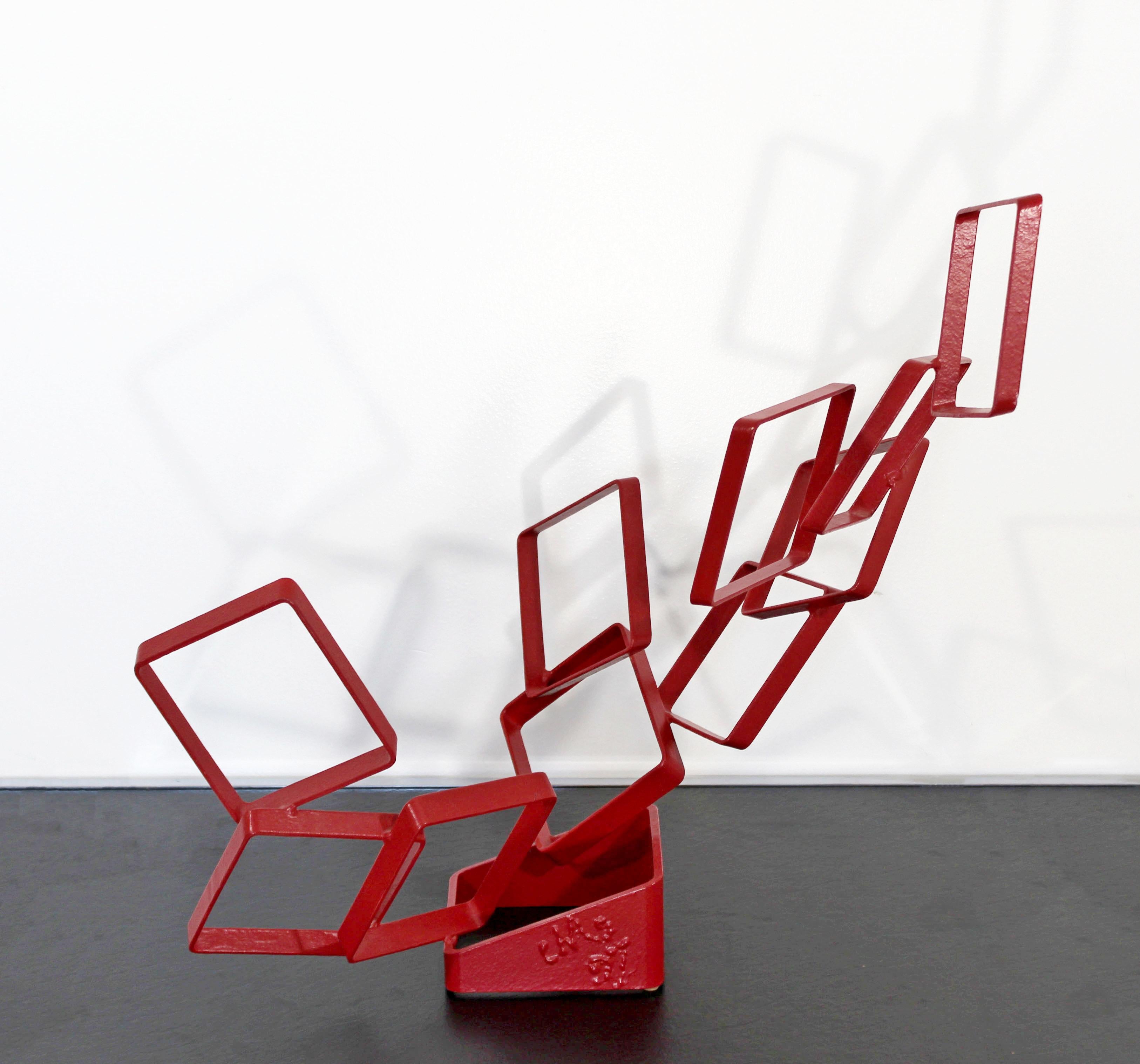 For your consideration is an abstract, red painted metal table sculpture, signed and dated by Cynthia McKean, circa 1997. In excellent condition. The dimensions are 20