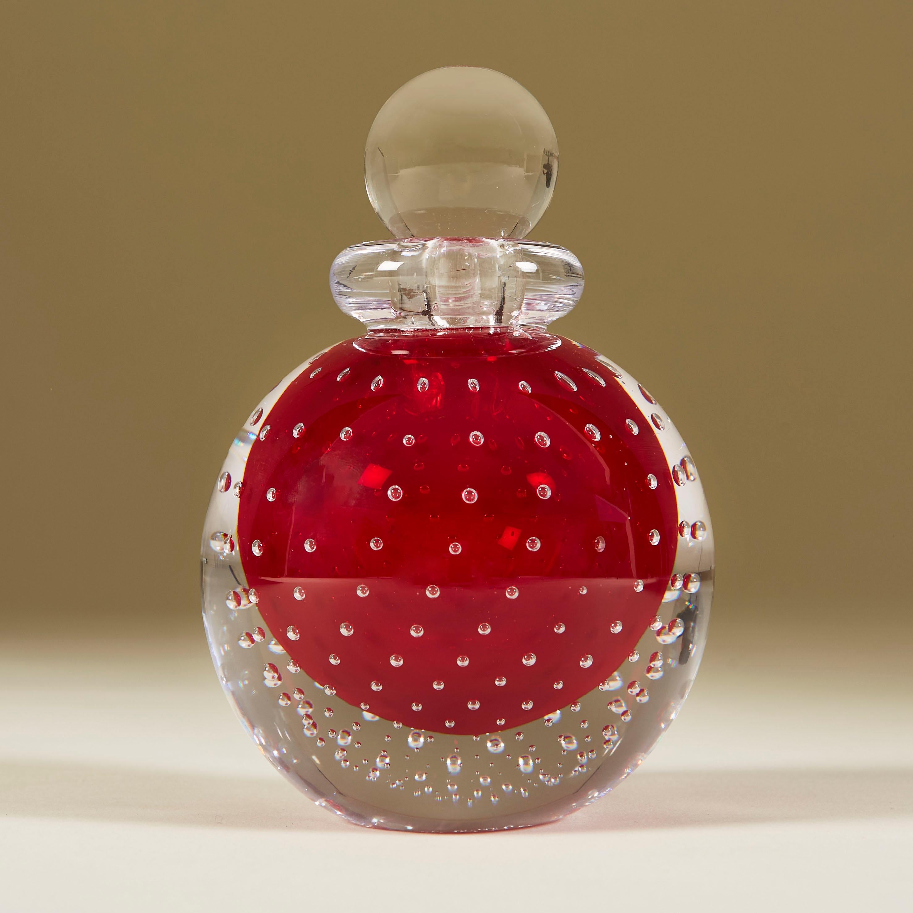 Rich red Bullicante ball perfume bottle cased in clear Murano glass with clear glass collar and ball stopper.

Made famous in the 1930s by Archimede Seguso, the Bullicante controlled bubbles technique involves overlaying several layers of air