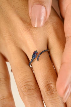 Contemporary Red Ruby Eye Pave Blue Sapphire Thin Snake Ring in 18k White Gold