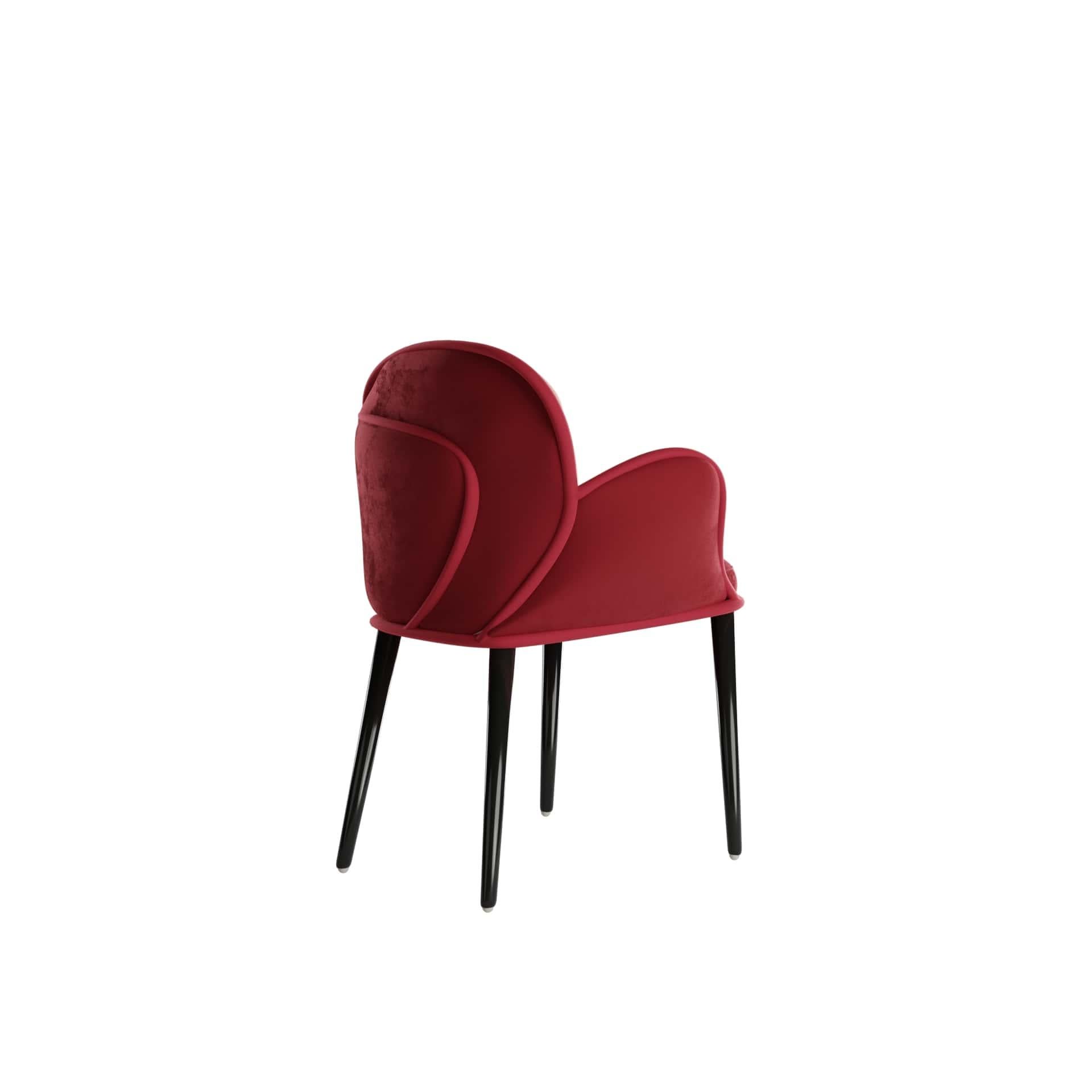 Scille Dining Chair is a luxury armchair that features an asymmetric seat composed of curvilinear panels that intersect each other. An original and comfortable dining chair, upholstered in velvet, ideal for a contemporary dining room