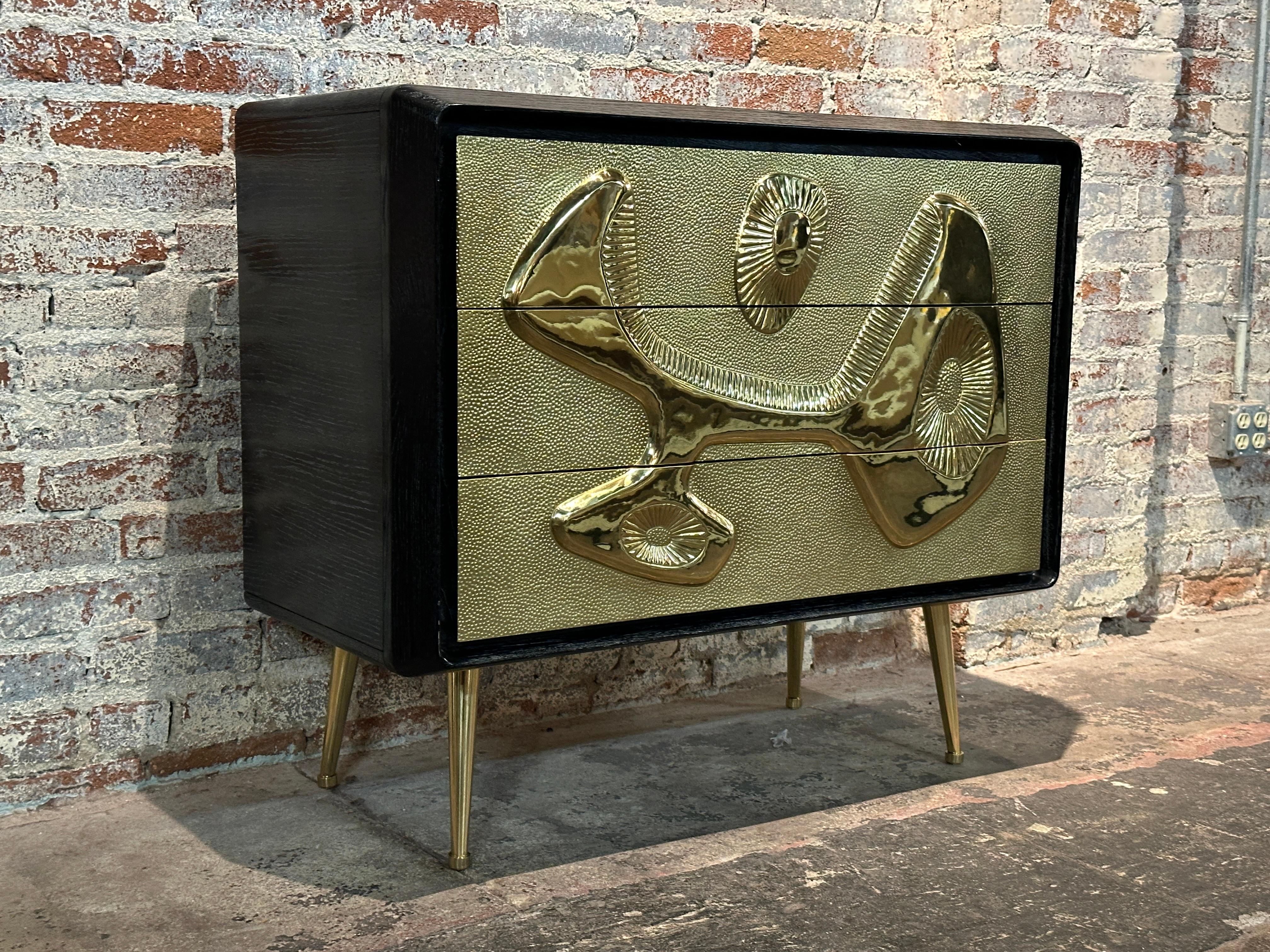 
This Contemporary Reform Black and Gold Chest of Drawers by Jonathan Adler  pictorials the designer's commitment to creating distinctive pieces that transcend the ordinary.
It retains its original signature brass plate 

This chest of drawers