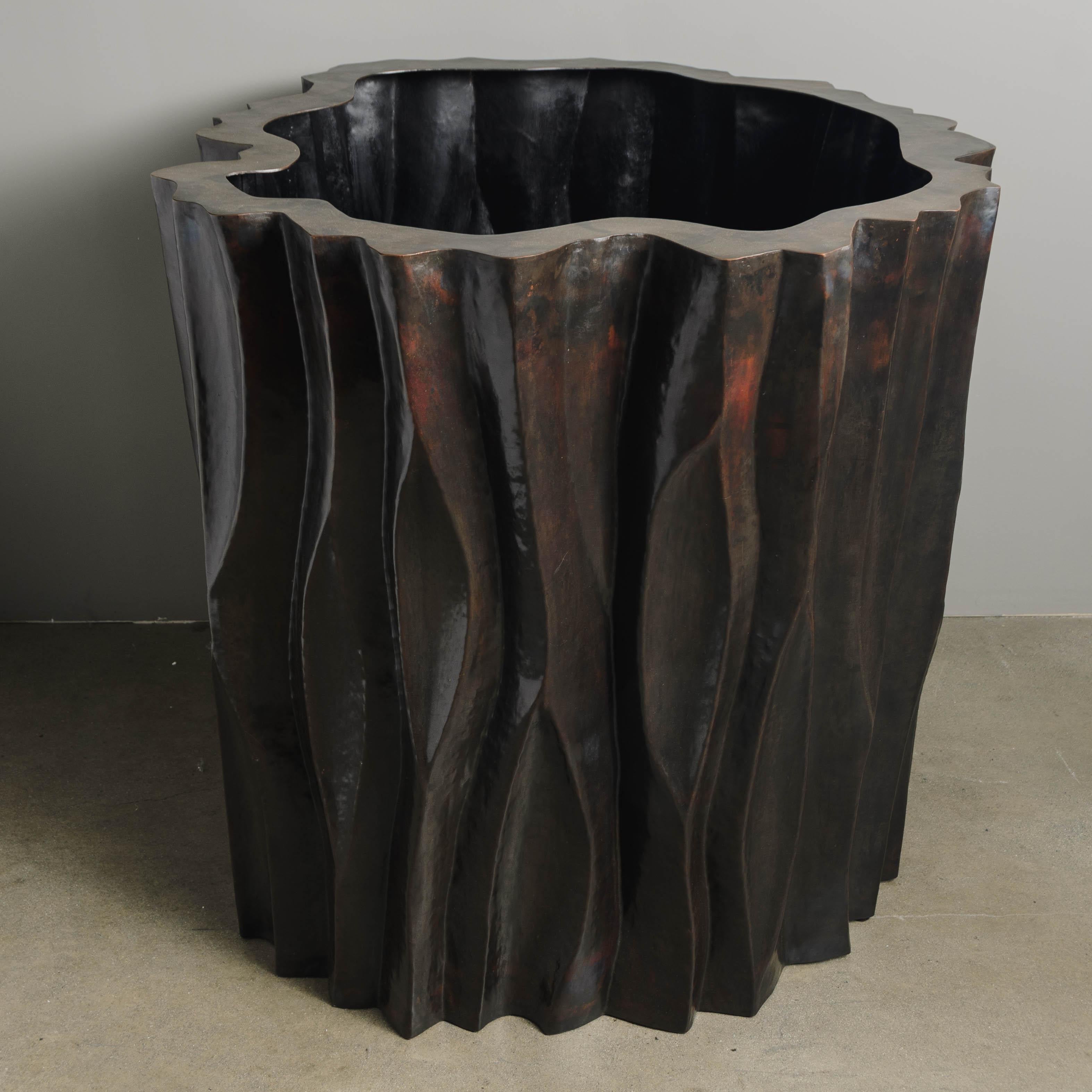 Large tree trunk design pot
Dark antique copper
Hand Repoussé
Limited Edition 
Each piece is individually crafted and is unique. 

Repoussé is the traditional art of hand-hammering decorative relief onto sheet metal. The technique originated