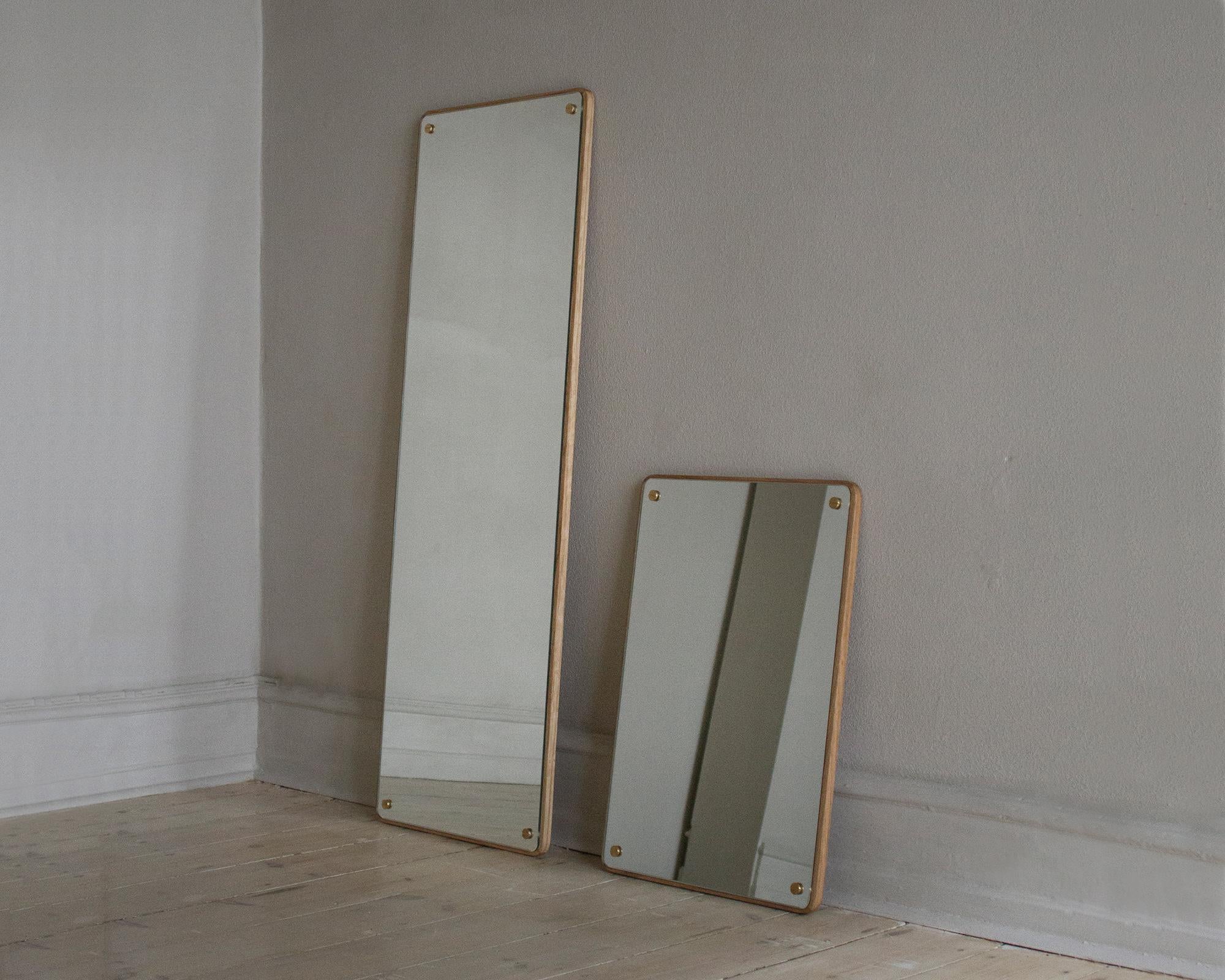 The rectangle mirror is an updated take on a classic standard. With carefully articulated sizing to fit a number of uses, the classic mirror is mounted to a solid oak back. Visible screws that celebrate the analog approach to construction are
