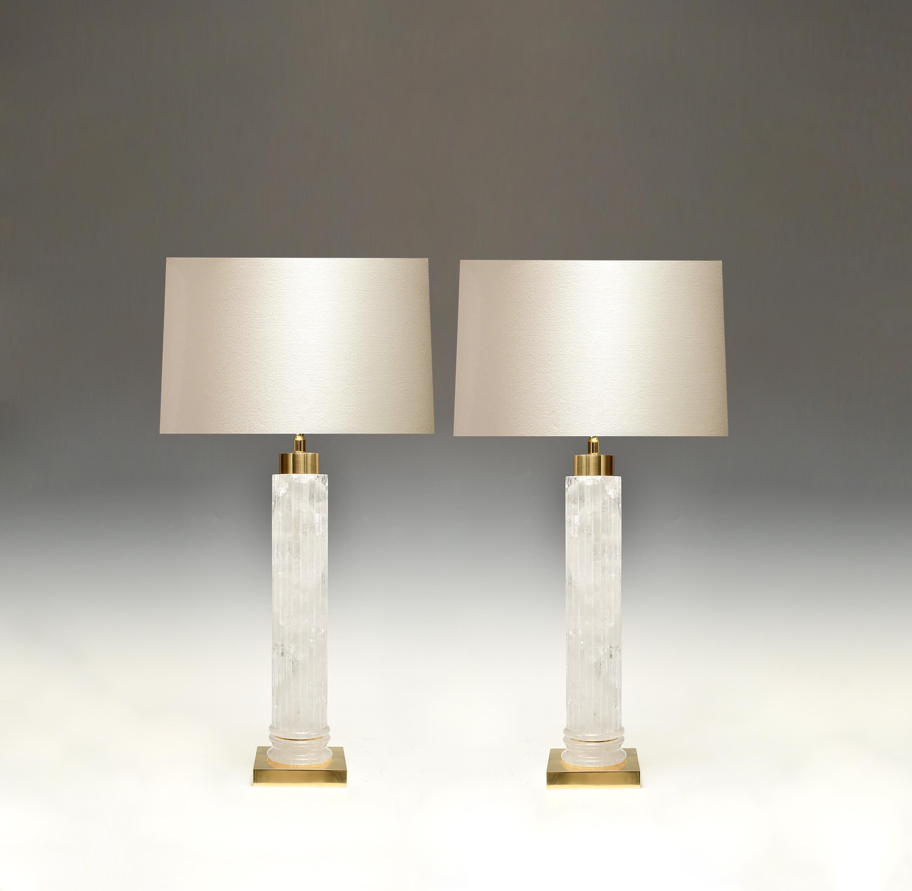 A pair of carved strips cylindrical rock crystal lamps with polished brass bases. Created by Phoenix Gallery.
Each lamp installs two sockets.
To the top of rock crystal: 17