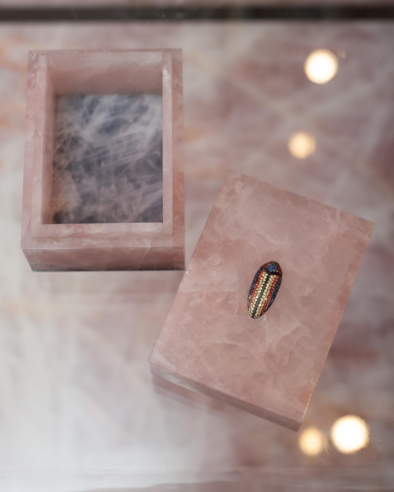 A true piece of jewellery for the home, this handmade pink rose quartz box is finished with a precision fit lid and base, featuring a natural sapphire pavé insect set into black rhodium vermeil. Elegant and opulent, this stunning box is a sparkling