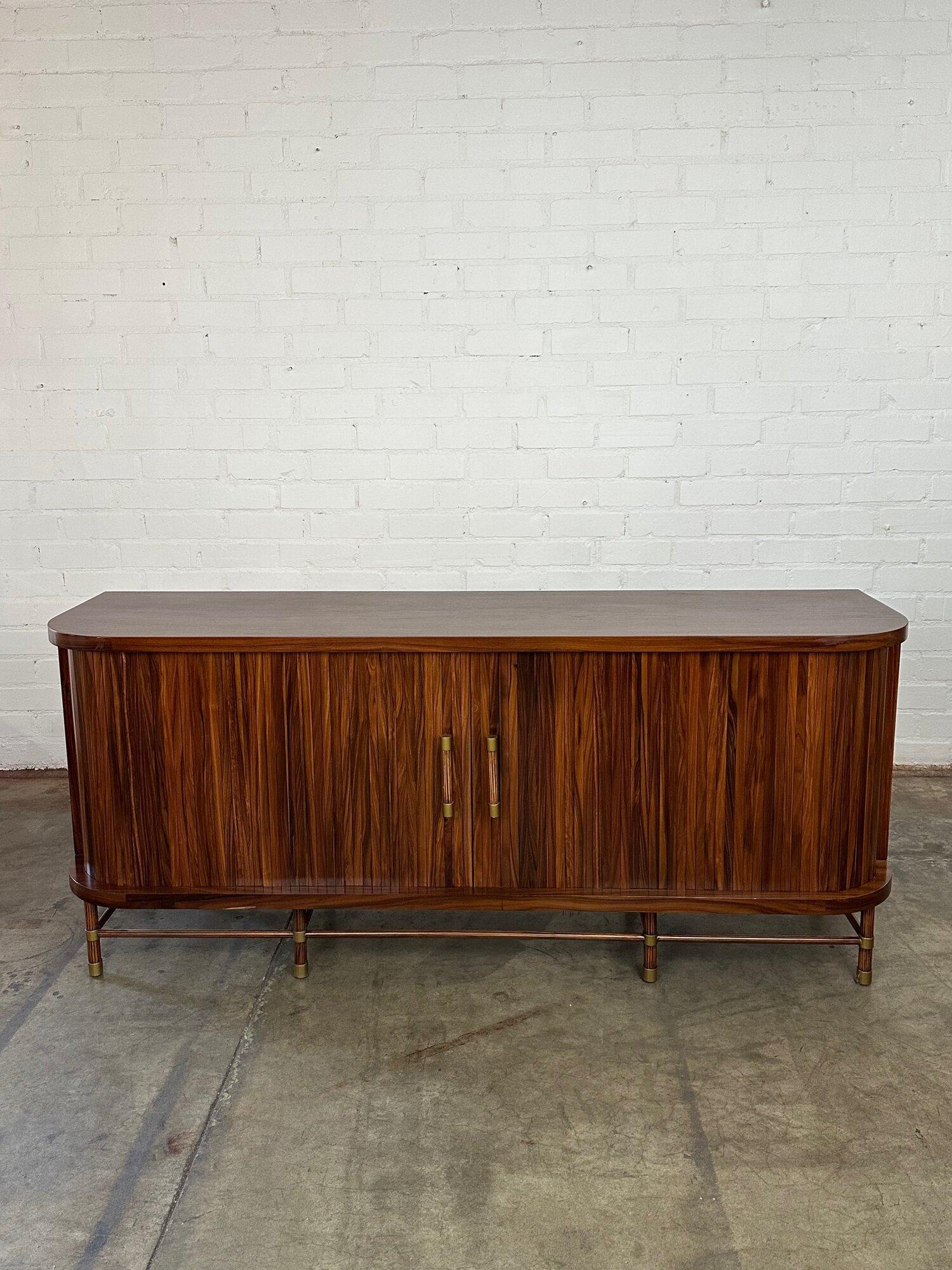 Measures: W76 D20 H32

Well preserved contemporary rosewood credenza. Item is structurally sound, sturdy and fully functional. Credenza features open back sections for wiring and sits on a strong base with cross bar supports. Pick this up at