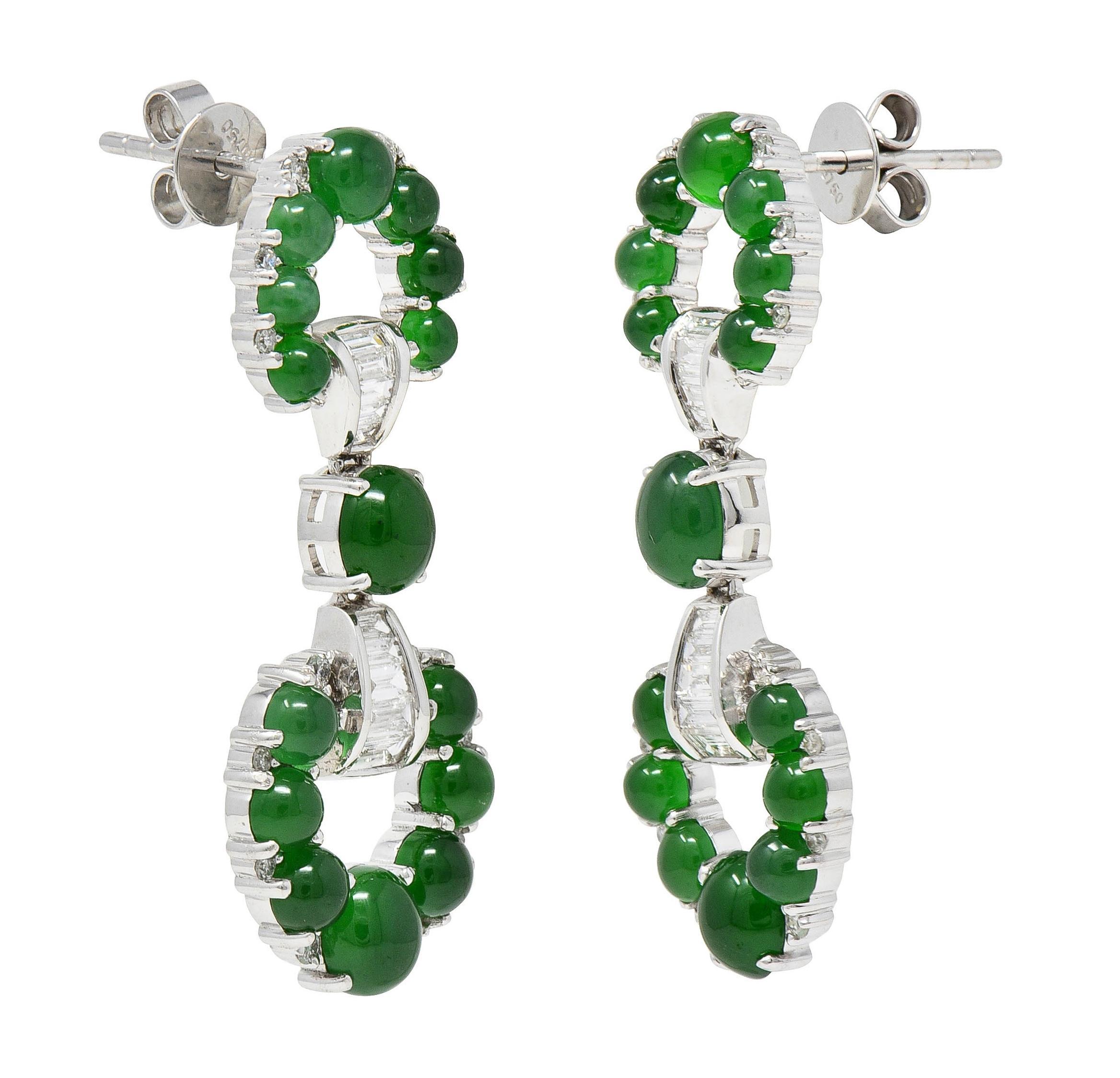 Designed as mirrored small and large knocker-shaped forms connected via bowtie station
Knocker motifs and station are prong set throughout with graduated jade cabochons 
Oval and round shaped - ranging in size from 2.0 mm to 5.0 mm 
Well-matched