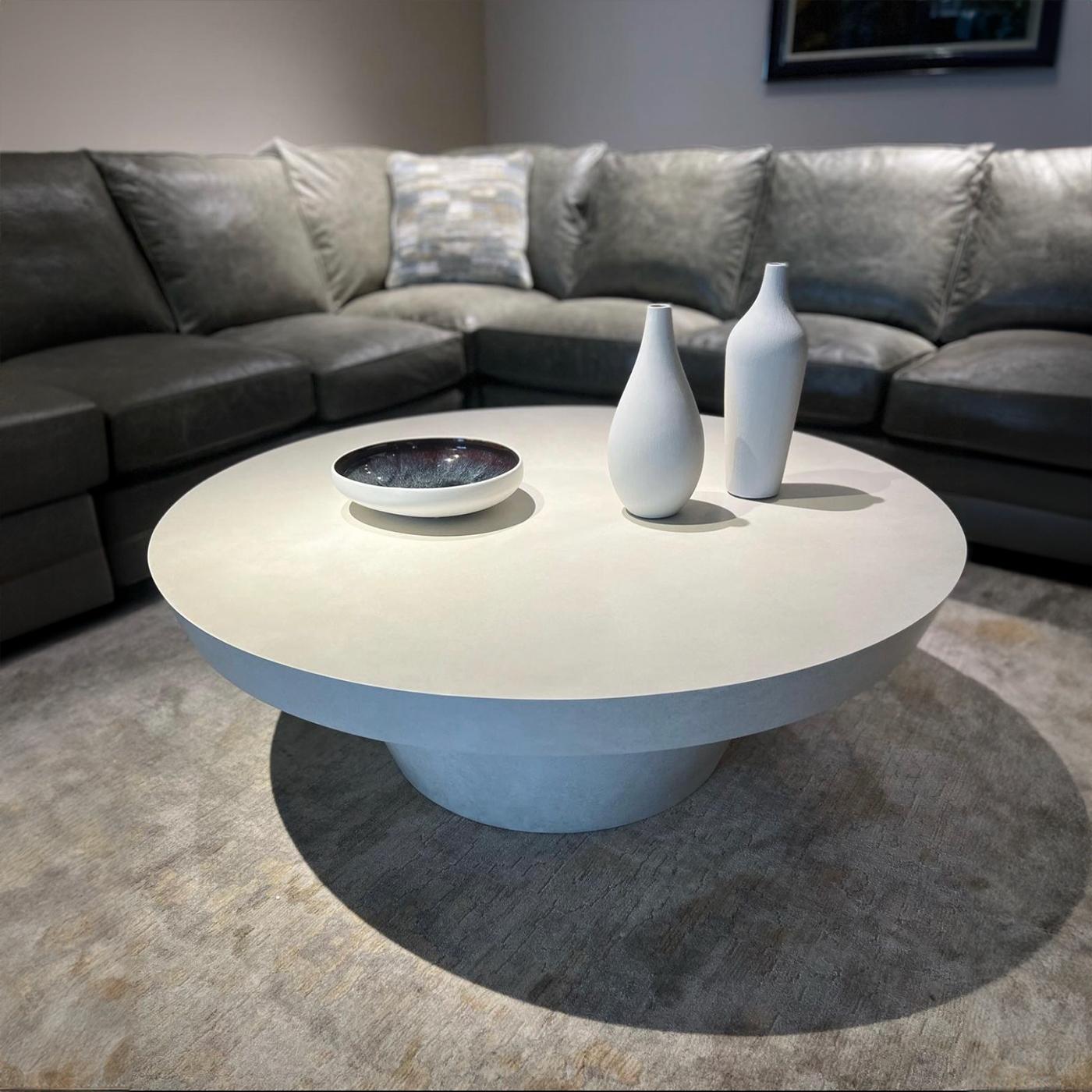 Contemporary round coffee table with a thick, tapered top edge and raised on a tapered plinth base. 

The Egret taupe-white lacquer finish with a satin sheen adds a luxurious touch, creating a seamless and polished look.

Dimensions: 48
