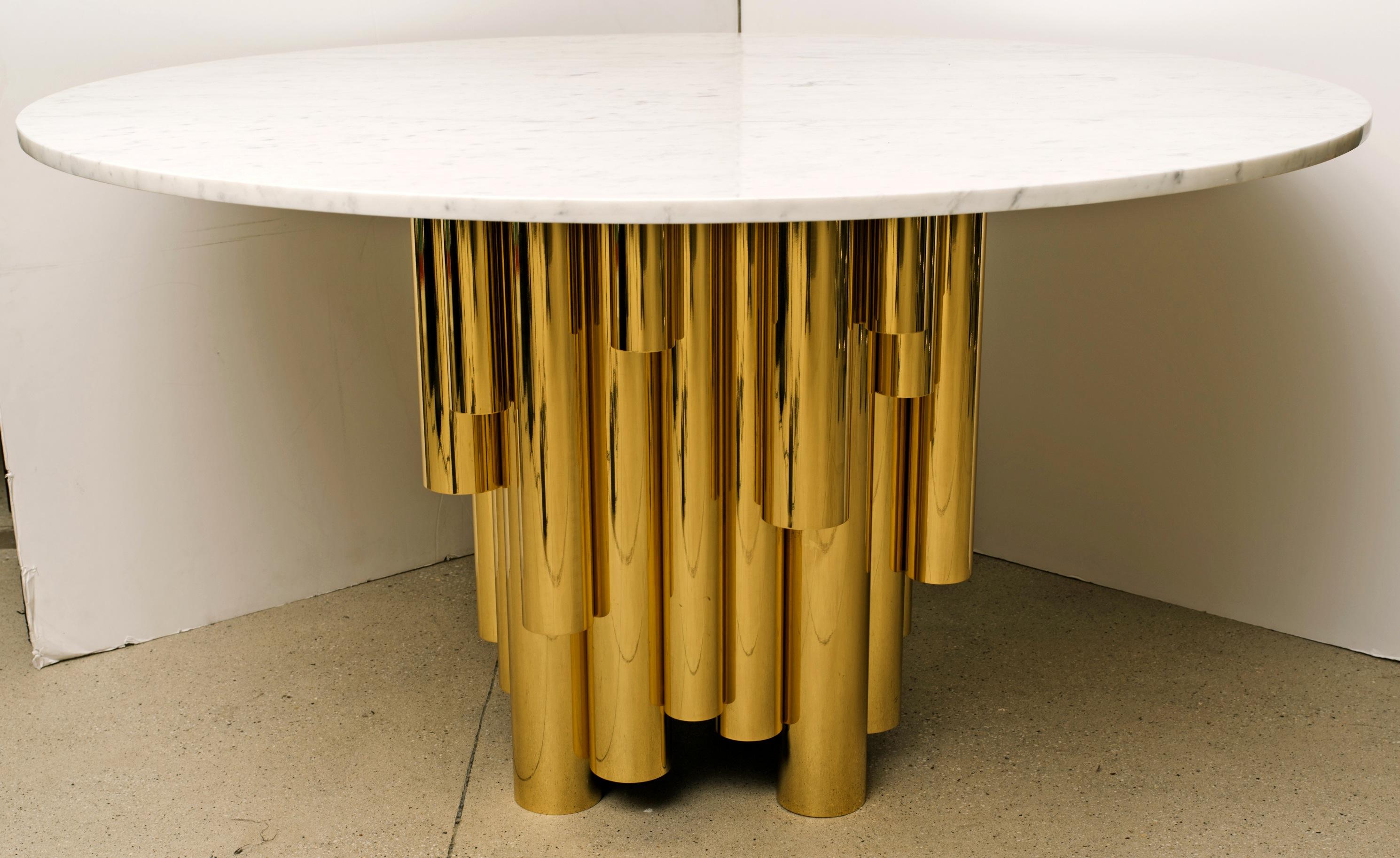 Contemporary round marble-top table with brass tubular base.