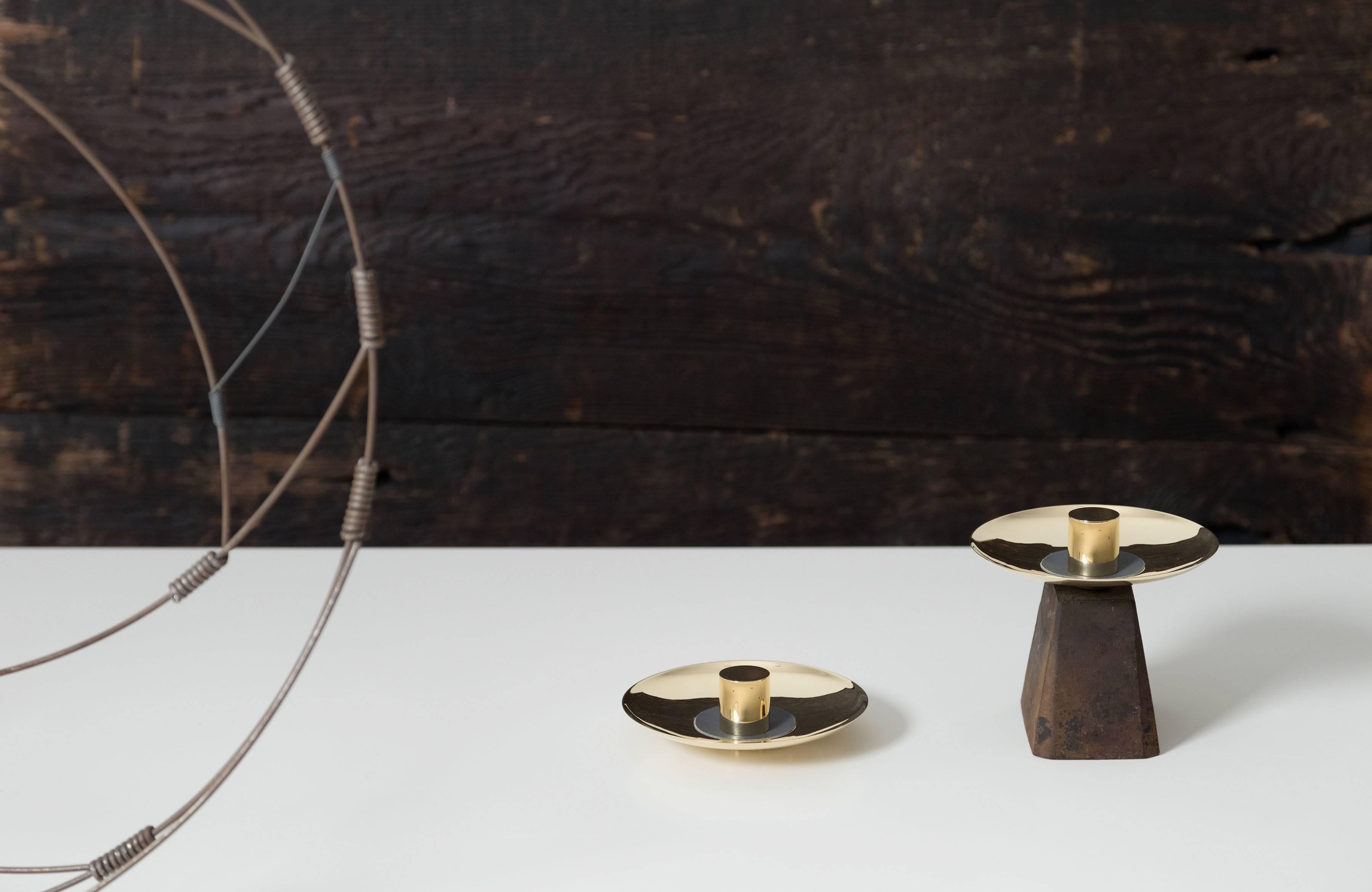 Part of Les Few's Julie collection, this contemporary, round, leather and brass, modern, Minimalist catch-all is made by artisans in Sweden. The leather comes in either anthracite gray or taupe. The brass is solid Swedish brass and the Italian