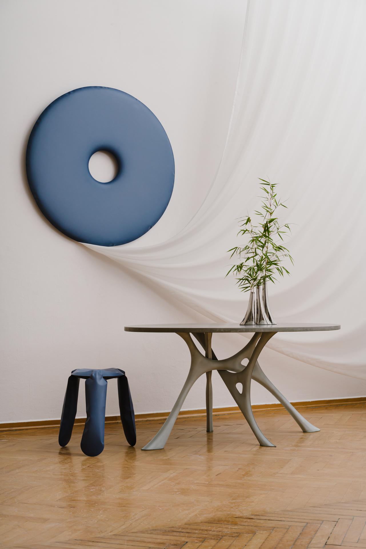 Round Table 'Morph' by Zieta

top: concrete
base: steel 
Dimensions. H: 74 cm W: 150 cm L: 120 cm

The MORPH table takes inspiration from the changing yet always optimized geometry of tree branches. Similar to organic forms flowing and