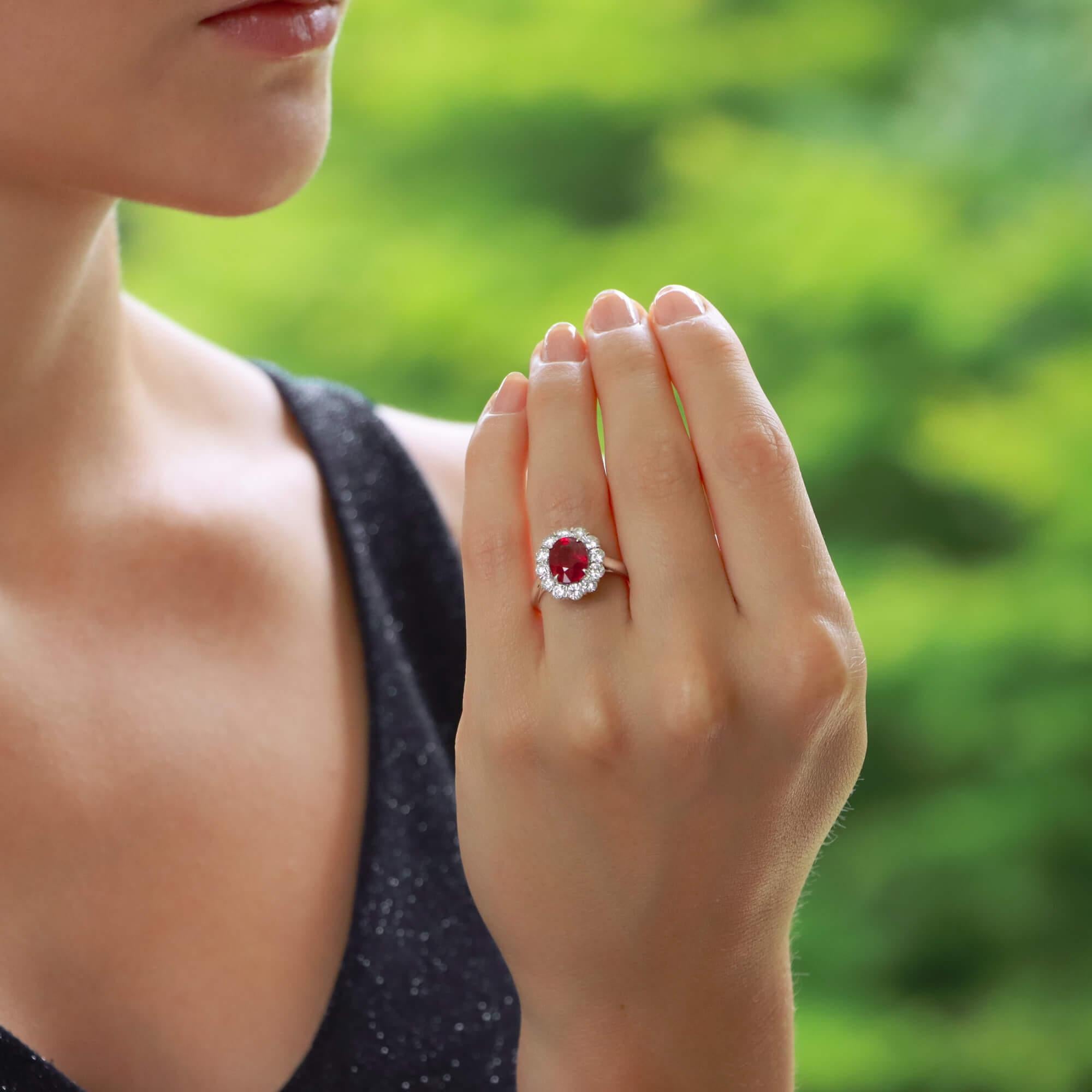 Oval Cut Contemporary Ruby and Diamond Cluster Engagement Ring Set in Platinum For Sale