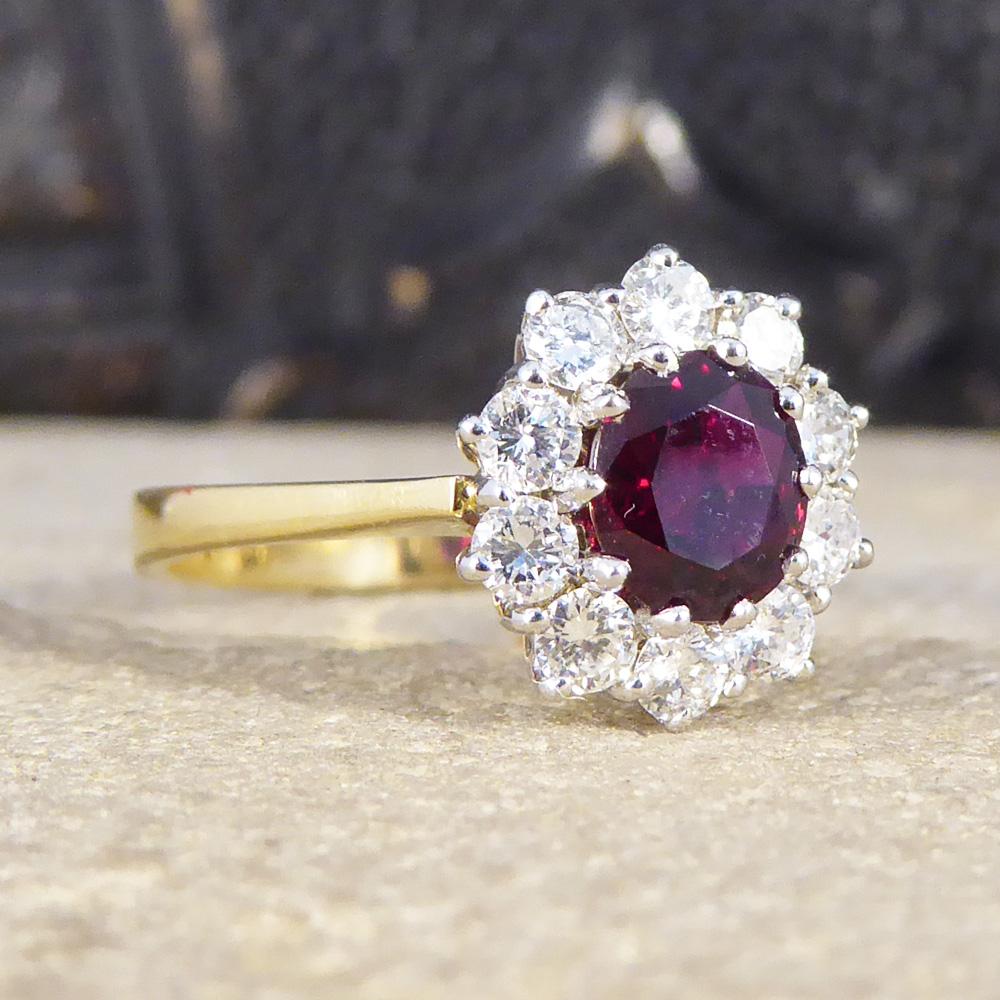 This contemporary ring was hand crafted in 1990 with very clear hallmarks. With a 0.75ct Oval cut Ruby in the centre and ten modern brilliant cut Diamonds surrounding it weighing 0.40ct in total, this ring is a beautiful example of a bright cluster