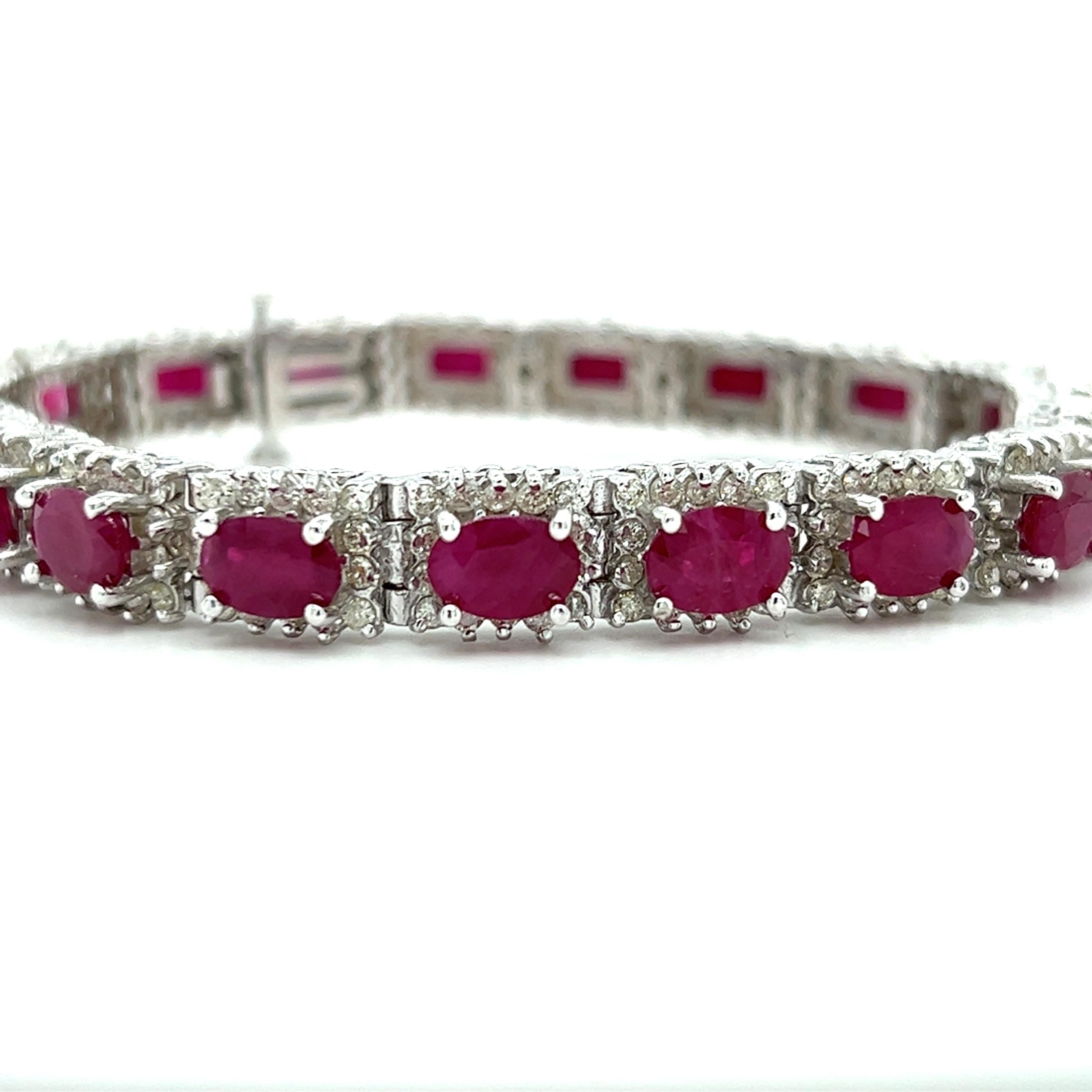 One 14 karat white gold line bracelet set with nineteen (19) 7x5mm oval pink rubies, approximately 12.00 carats total weight and two hundred sixty-five round brilliant cut diamonds, approximately 2.25 carats total weight with matching H/I color and