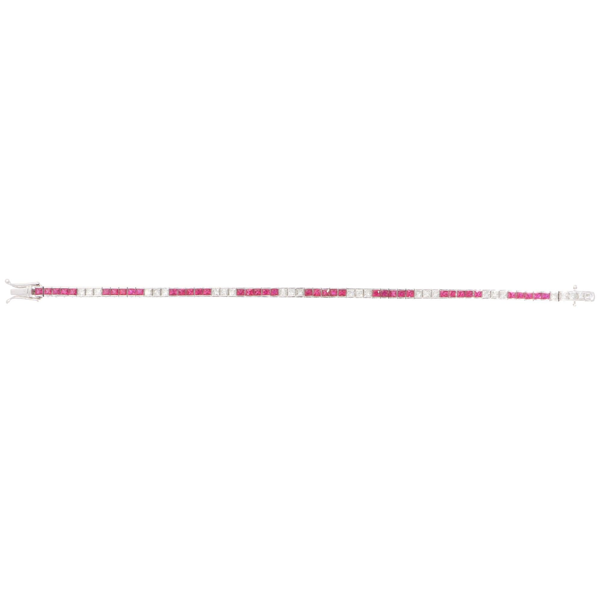 A beautiful contemporary ruby and diamond line tennis bracelet set in 18k white gold.

The bracelet is composed of a grand total of 40 square scissor-cut vibrant rubies and 25 French-cut diamonds. All stones are securely channel set and alternate