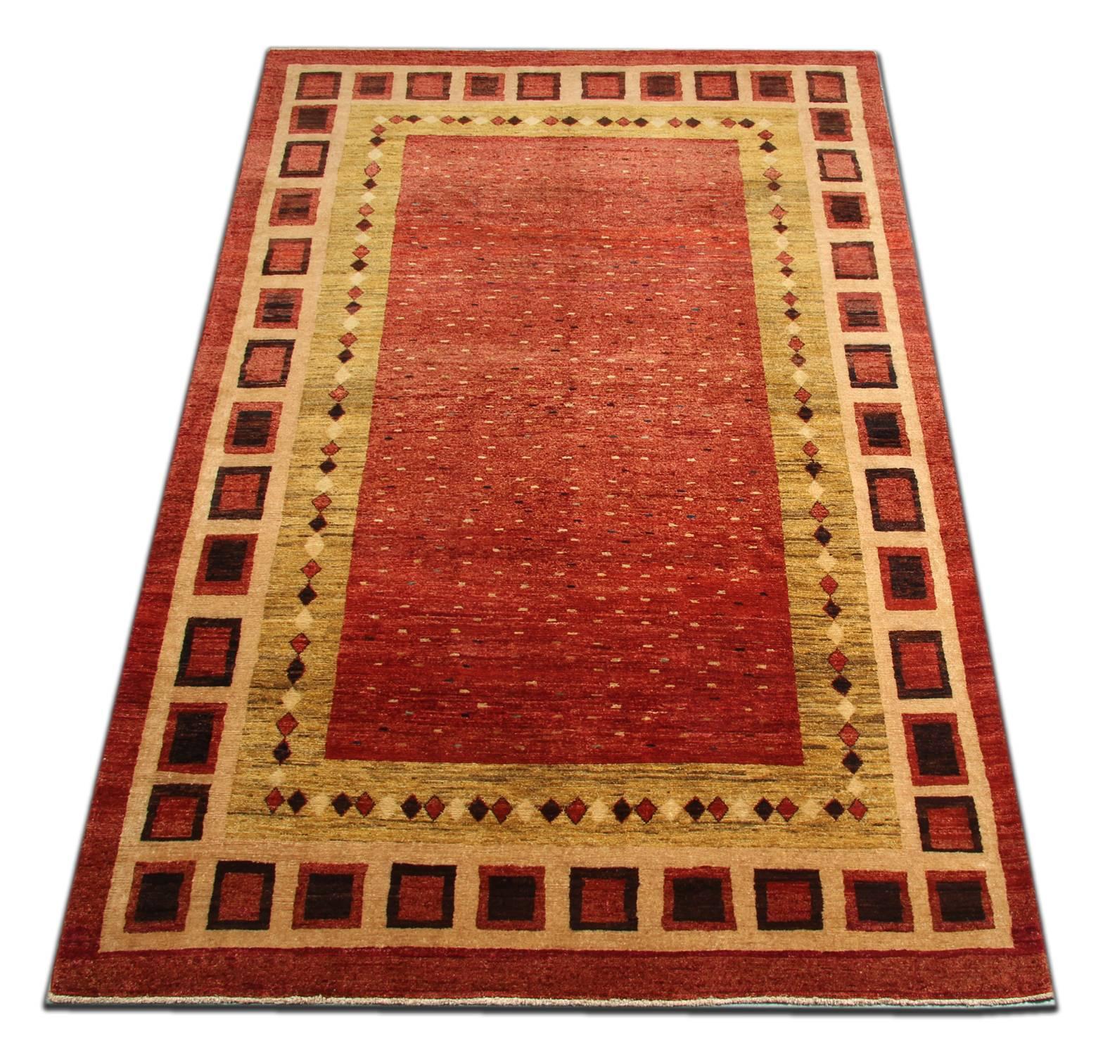 With rich colors and abstract elements, this modern woven rug gives a subtle contemporary appearance. Featuring a beautiful red palette of gold, navy and green colors, this golden red rug is grounded in stylish colors that will add a touch of