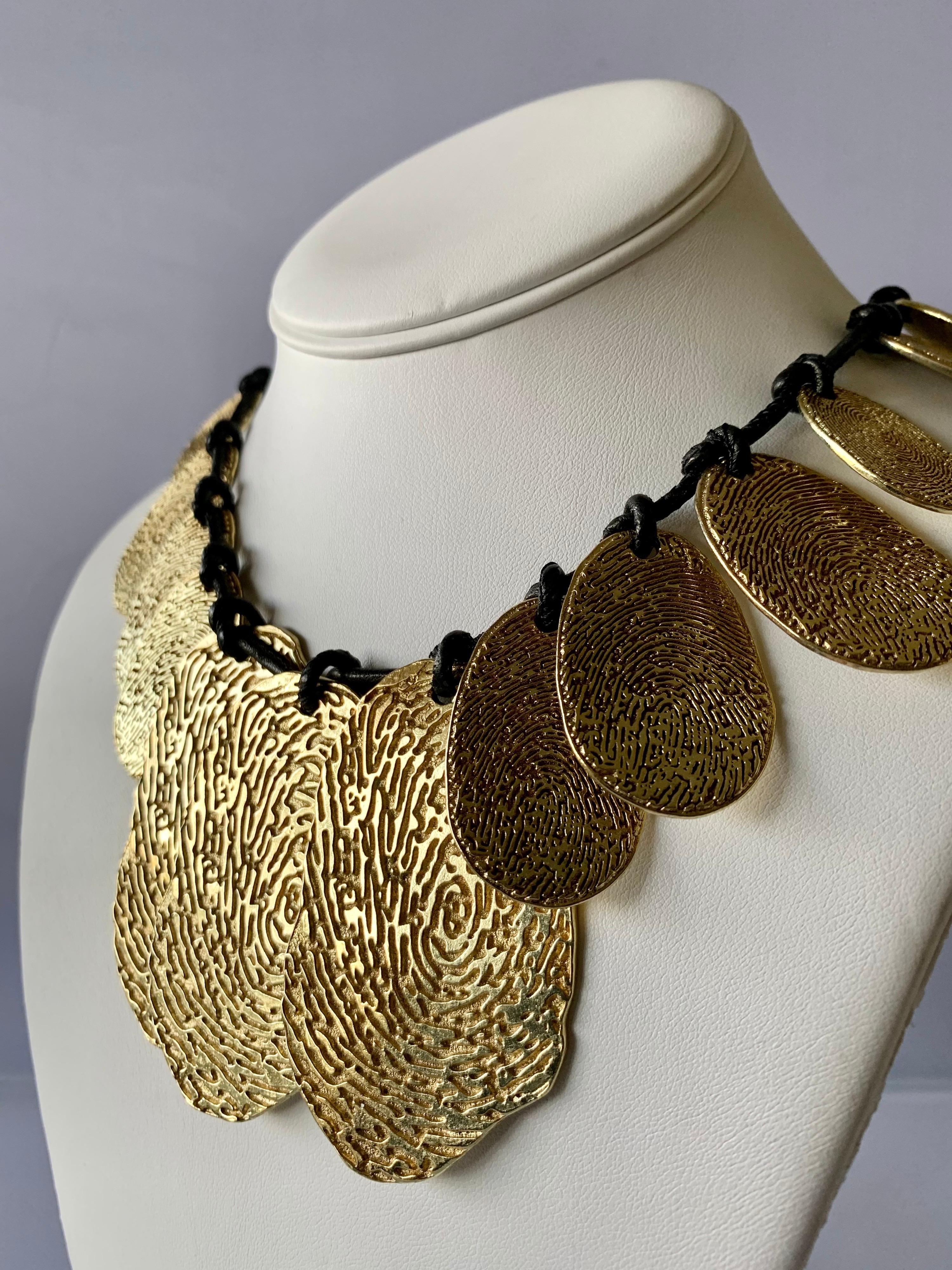 Contemporary  Yves Saint Laurent gold-tone high polish fingerprint statement necklace with adjustable cord - designed by Stefano Pilati for YSL in spring/summer 2011. Signed YSL.