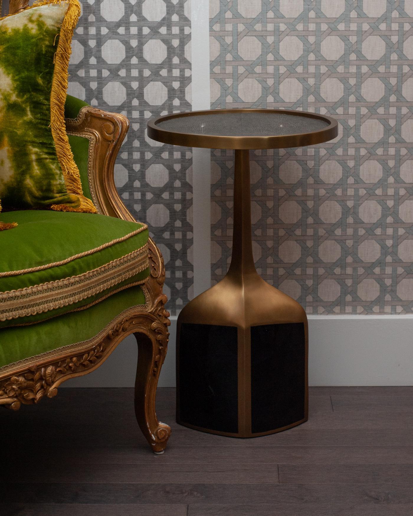 The Pedestal drinks/side table is the perfect accent piece due to it’s sleek and light aesthetic - inlaid with charcoal natural shagreen and black penshell. Constructed from a base of brass and walnut with designer signature on underside of the