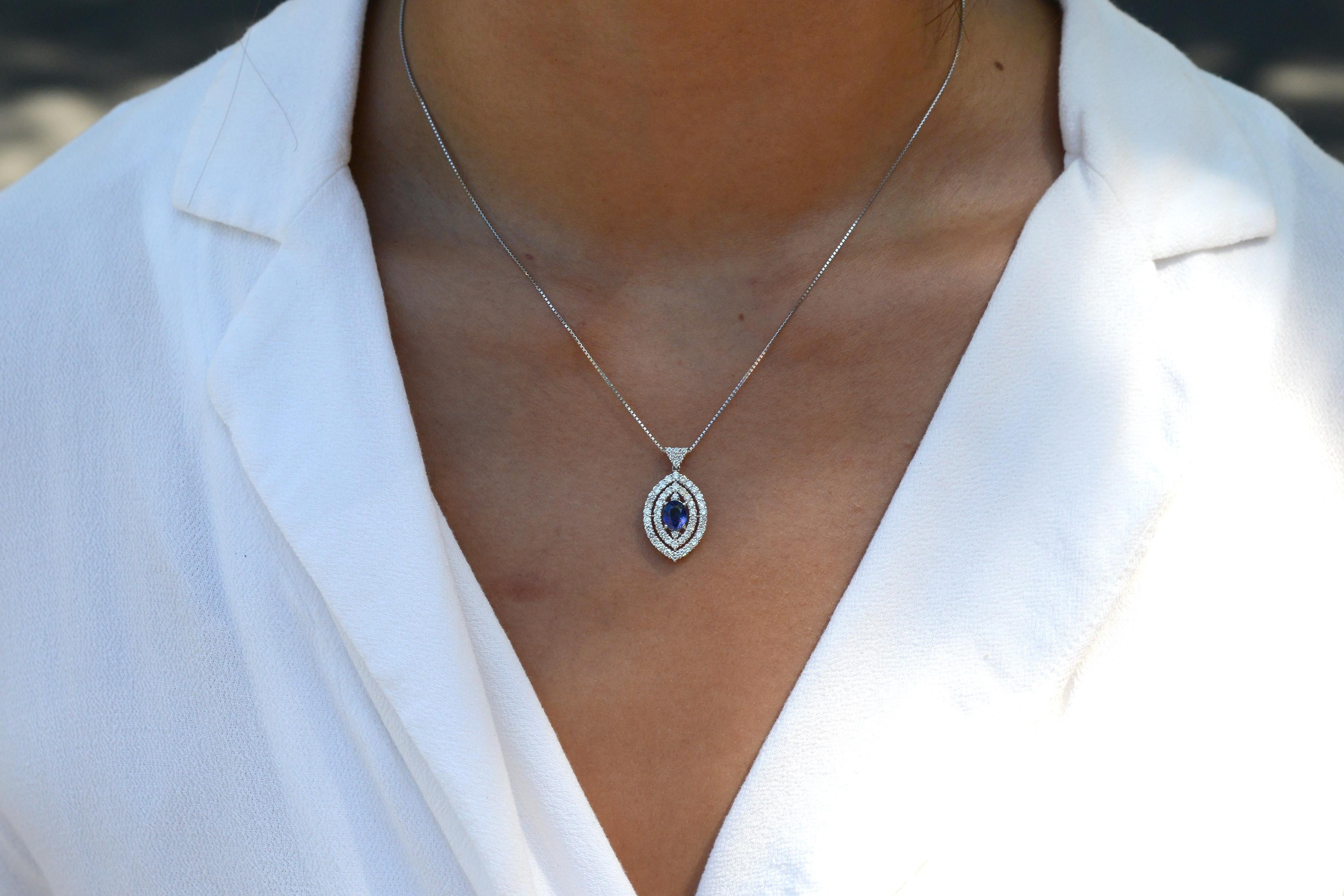 This stunning contemporary bolo necklace features a unique double halo design with an adjustable chain length for easy styling. The central gemstone, a 1 carat natural oval sapphire with a vivid deep blue color. Encircled with 0.88 carats of natural