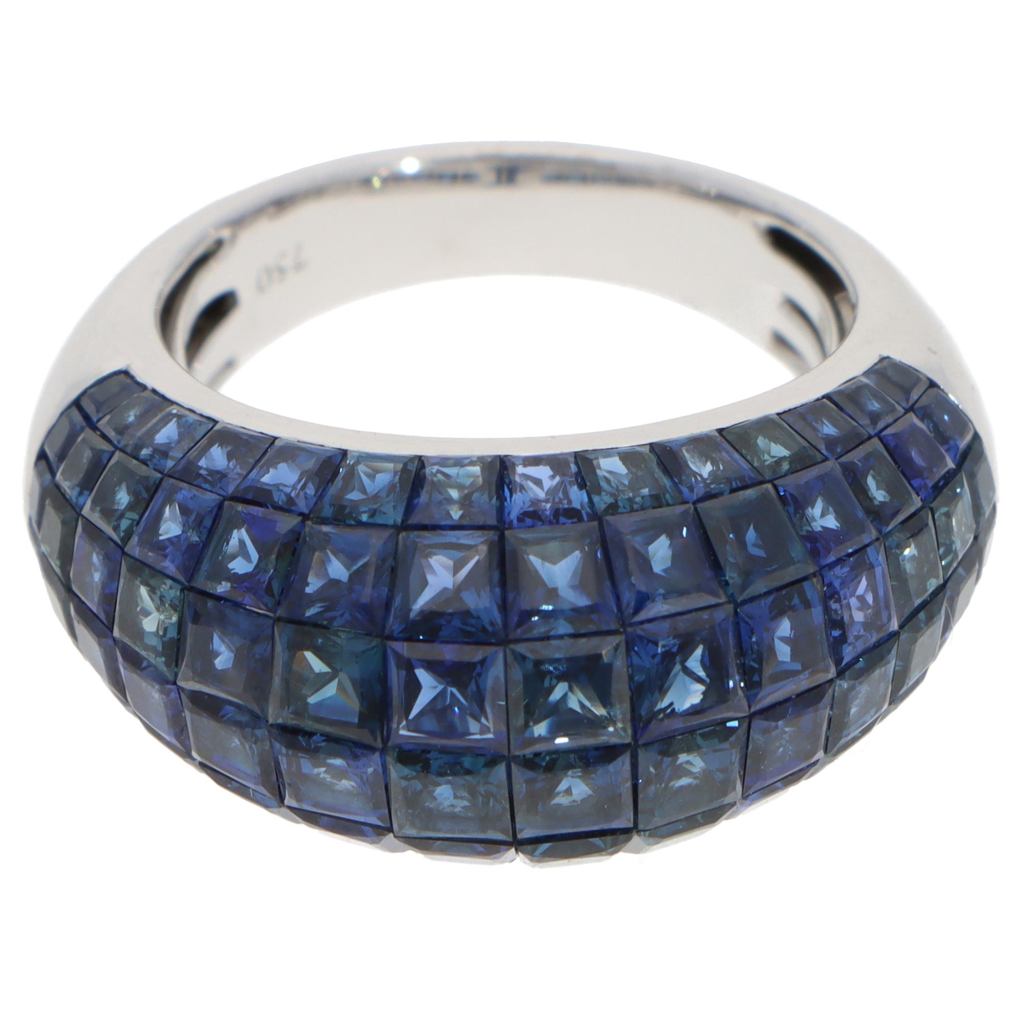 A beautiful contemporary sapphire invisible set ring set in 18k white gold.

The ring is composed of six rows of graduated-sized French-cut sapphires that perfectly match in colour and vibrancy, forming a bombe style. All the stones are securely
