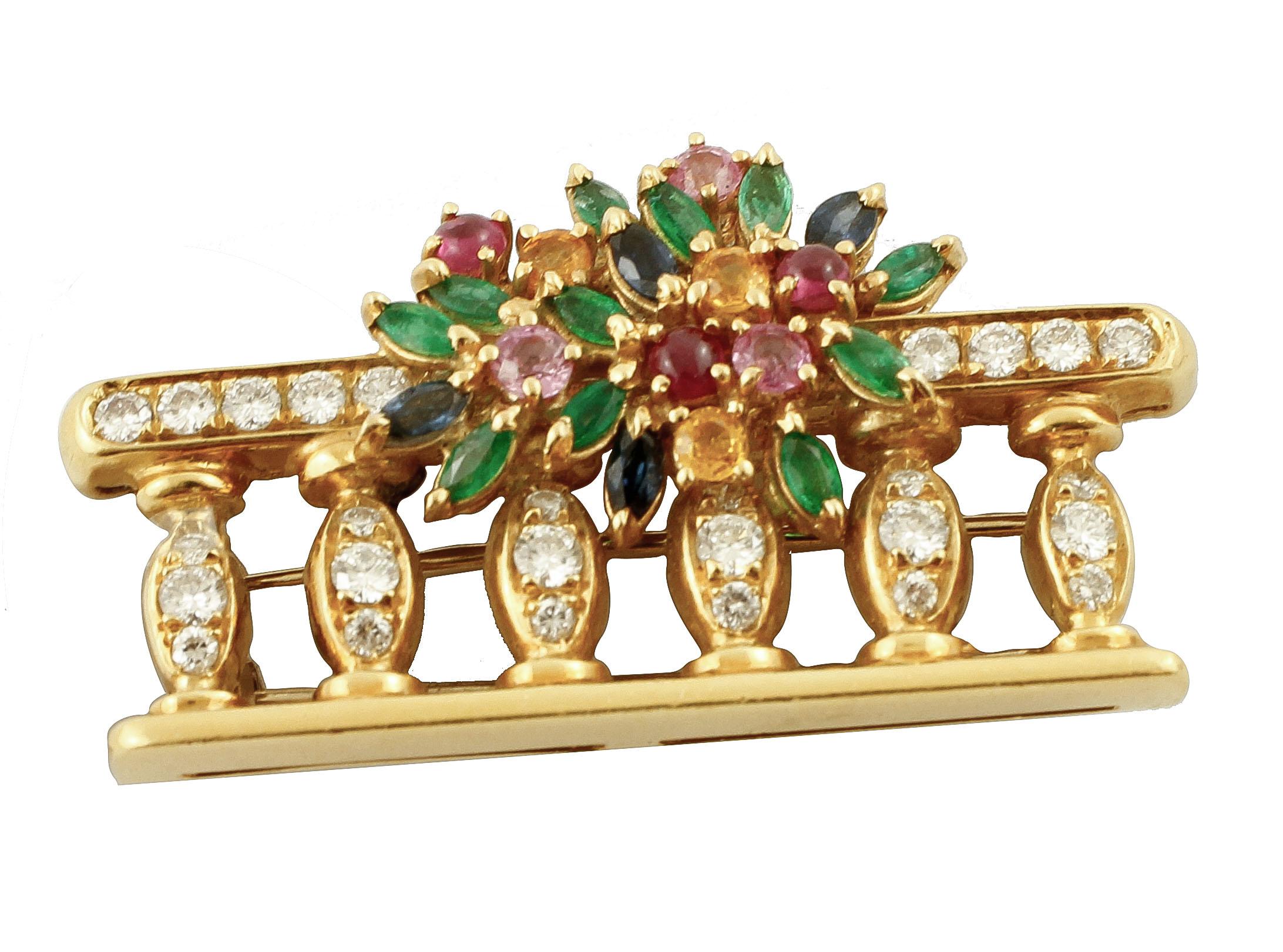 Classic brooch composed of a bouquet of emeralds, rubies, blue sapphires, on a balcony of diamonds, all is mounted in 18 Kt yellow gold. 
Tot weight 15.97 g
Diamonds 0.12 ct
Emeralds, rubies, blue sapphire, 2.2 ct

Rf. frgf