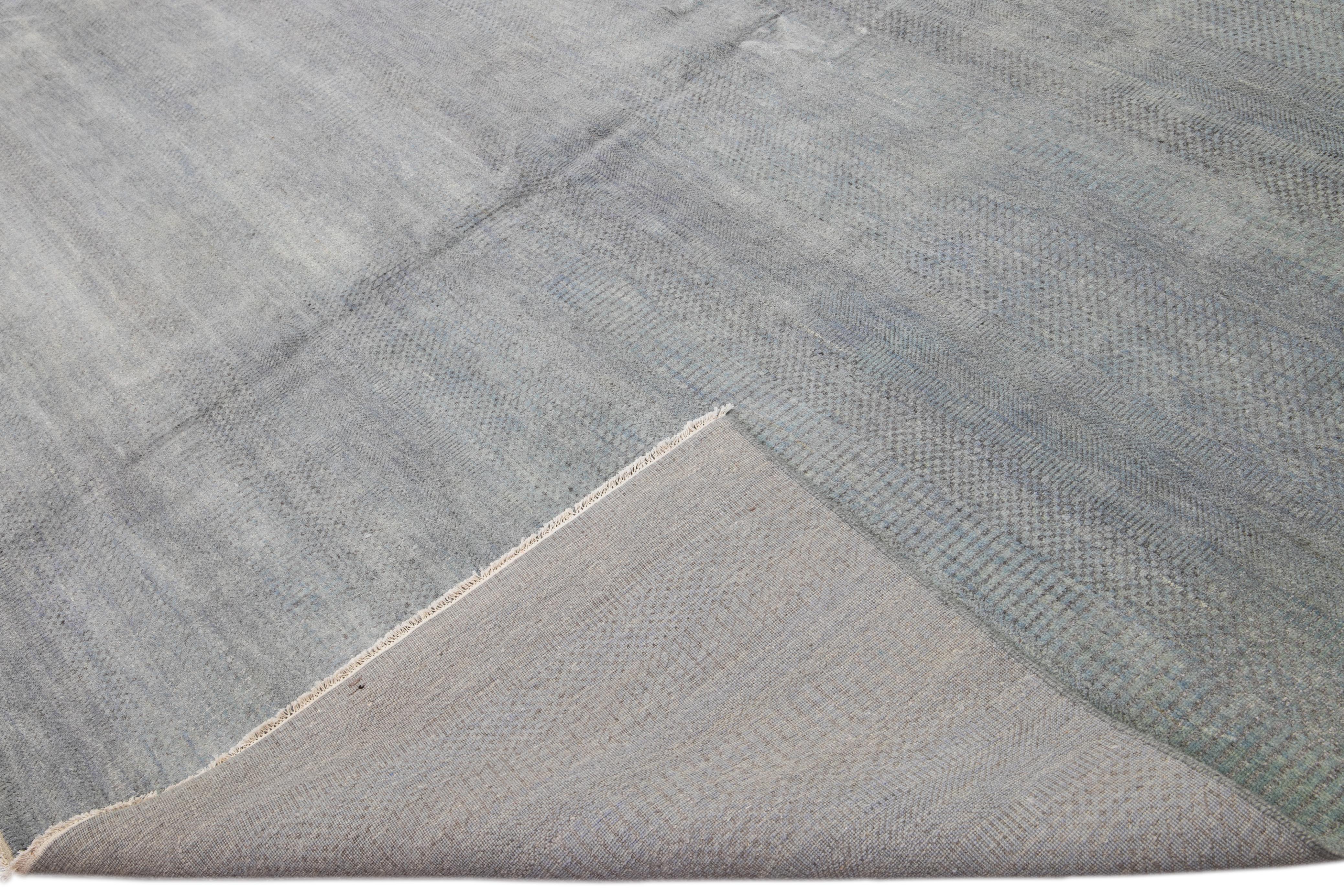 Beautiful Contemporary Savannah hand-knotted wool rug with a finely detailed gray field in an all-over geometric pattern design.

This rug measures: 16' x 22'9