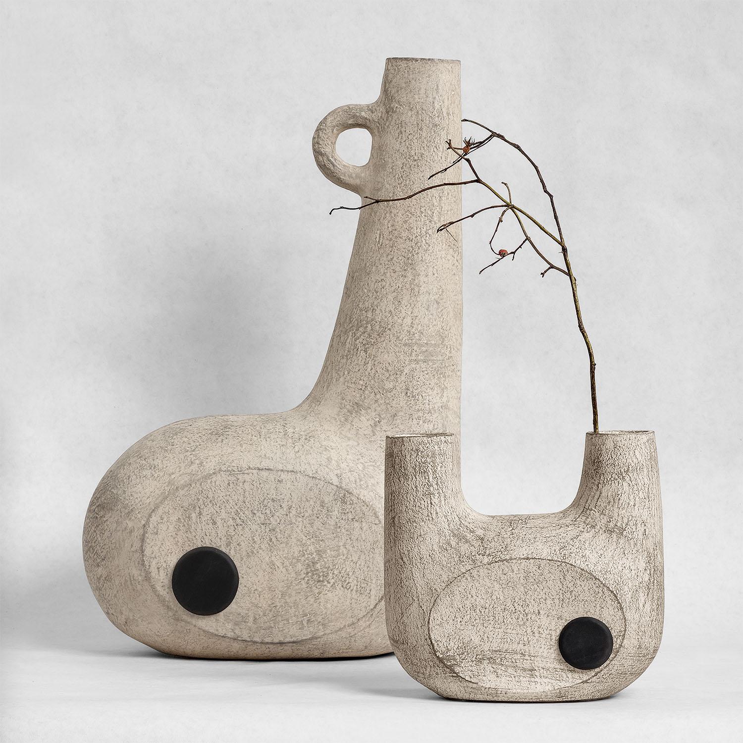 Contemporary sculpted pair of Ceramic vases - Bandura off white vases by Faina

Design: Victoriya Yakusha
Material: material: clay / ceramics
Dimensions:
Small: 20.5 x 9 x H 19 cm
Big: 31.5 x 15 x H 50 cm

Made in the style of ethnic minimalism, the
