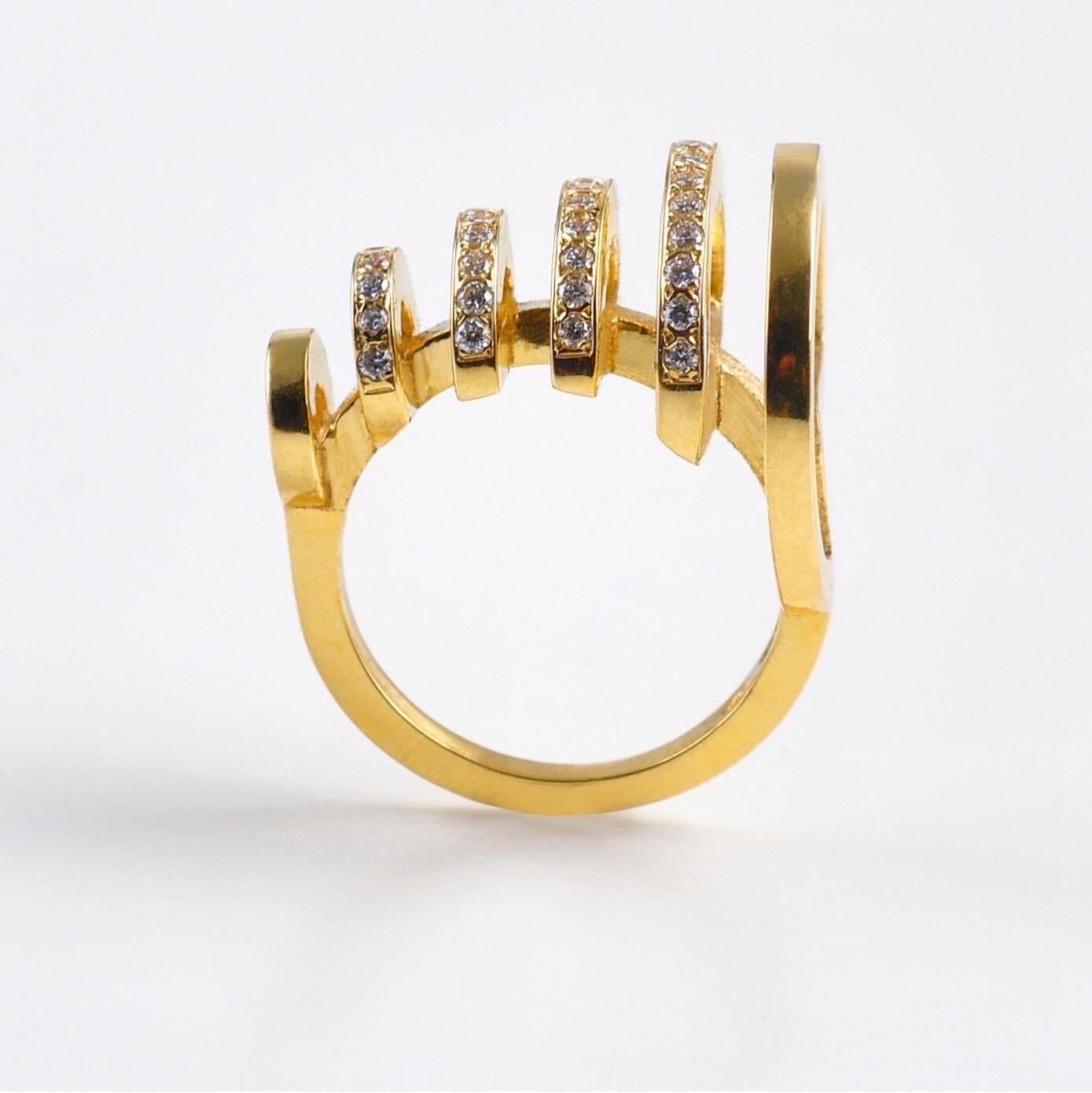 The 'Echo', ring is crafted in 18k gold, hallmarked in Cyprus. This stunning sculptural piece, comes in a highly polished finish and features white, VS Diamonds totaling 0.33 Cts. It will fit comfortably and would look great on a middle finger