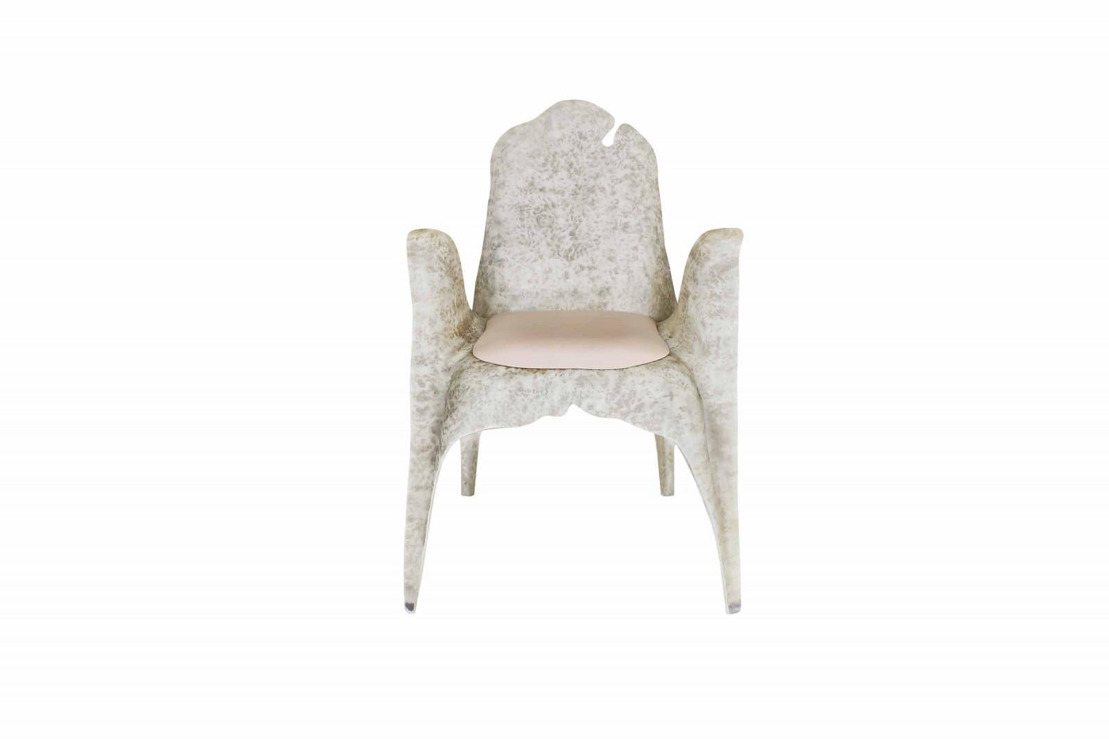 Contemporary dining chair built with resin reinforced fiberglass. This highly resistant material is very durable and requires no maintenance. The chairs are then given an metallic iron finish done by special artisans. Seat cushion upholstered