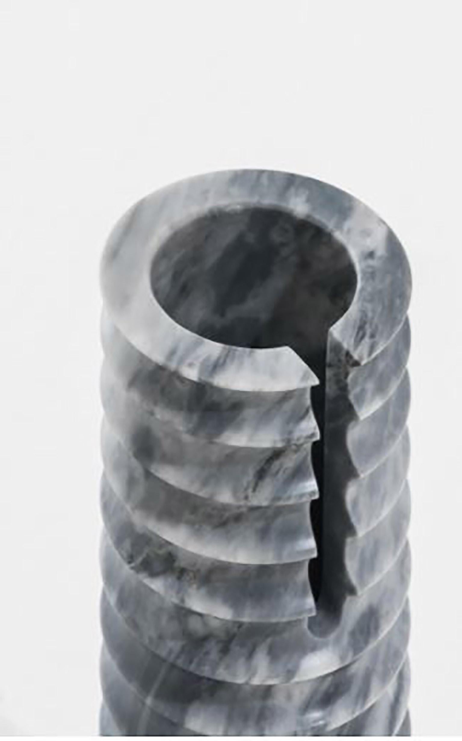 Geometric sculptural vase in Sodalite marble, Simultanea Collection. Centripetal, centrifugal, and movement forces are channeled into stone forms, and rotation on the axis becomes a vase, while an inclined cut suggests a container. Like a mechanical