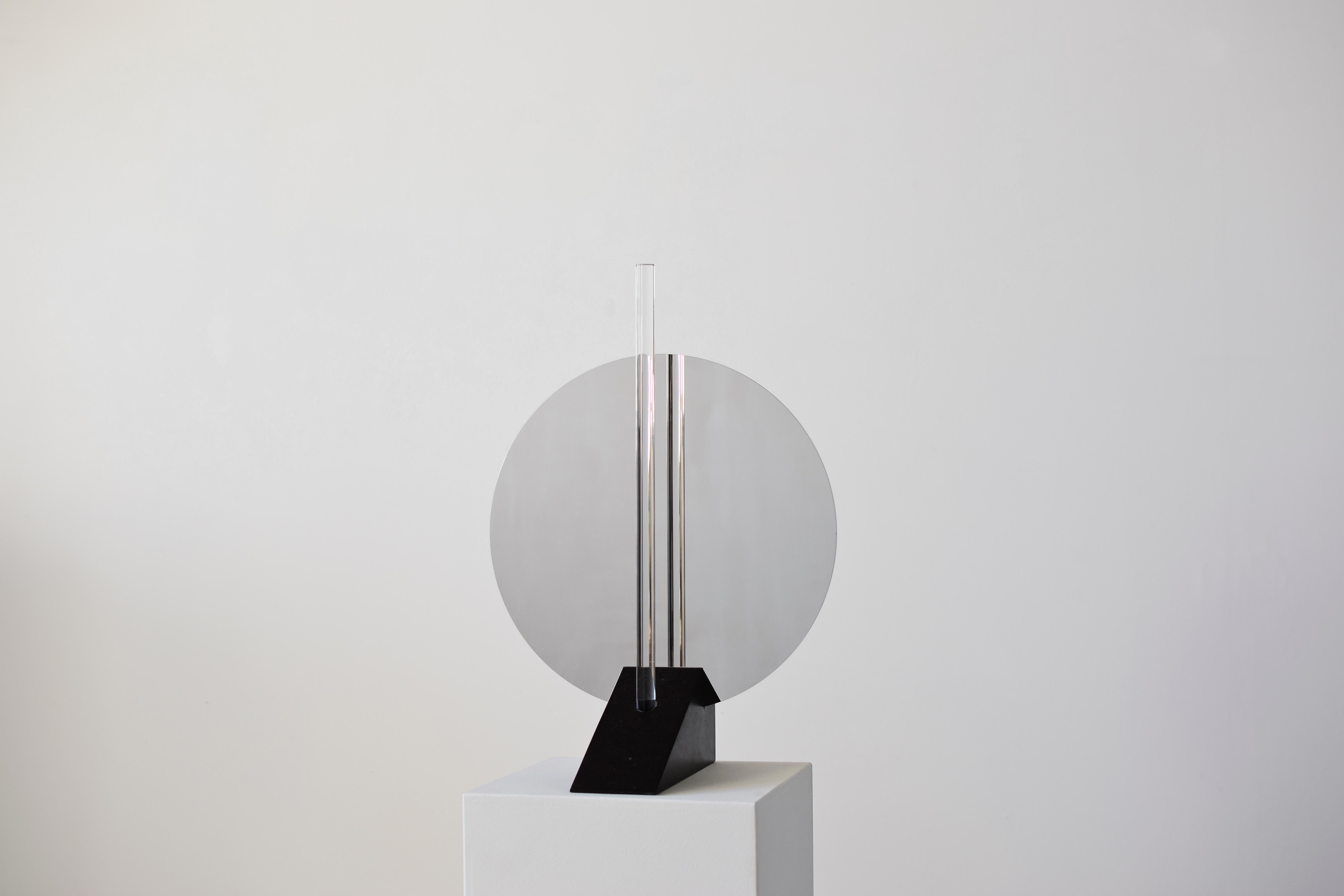 Elusive 02
A beautiful piece exploring the line between visible and invisible: half table lamp, half mirror, half sculpture.
By Maximilian Michaelis.

Belgium bluestone, polished stainless steel, arcylic glass, Led
Measures: 55 x 39 x 27 cm.