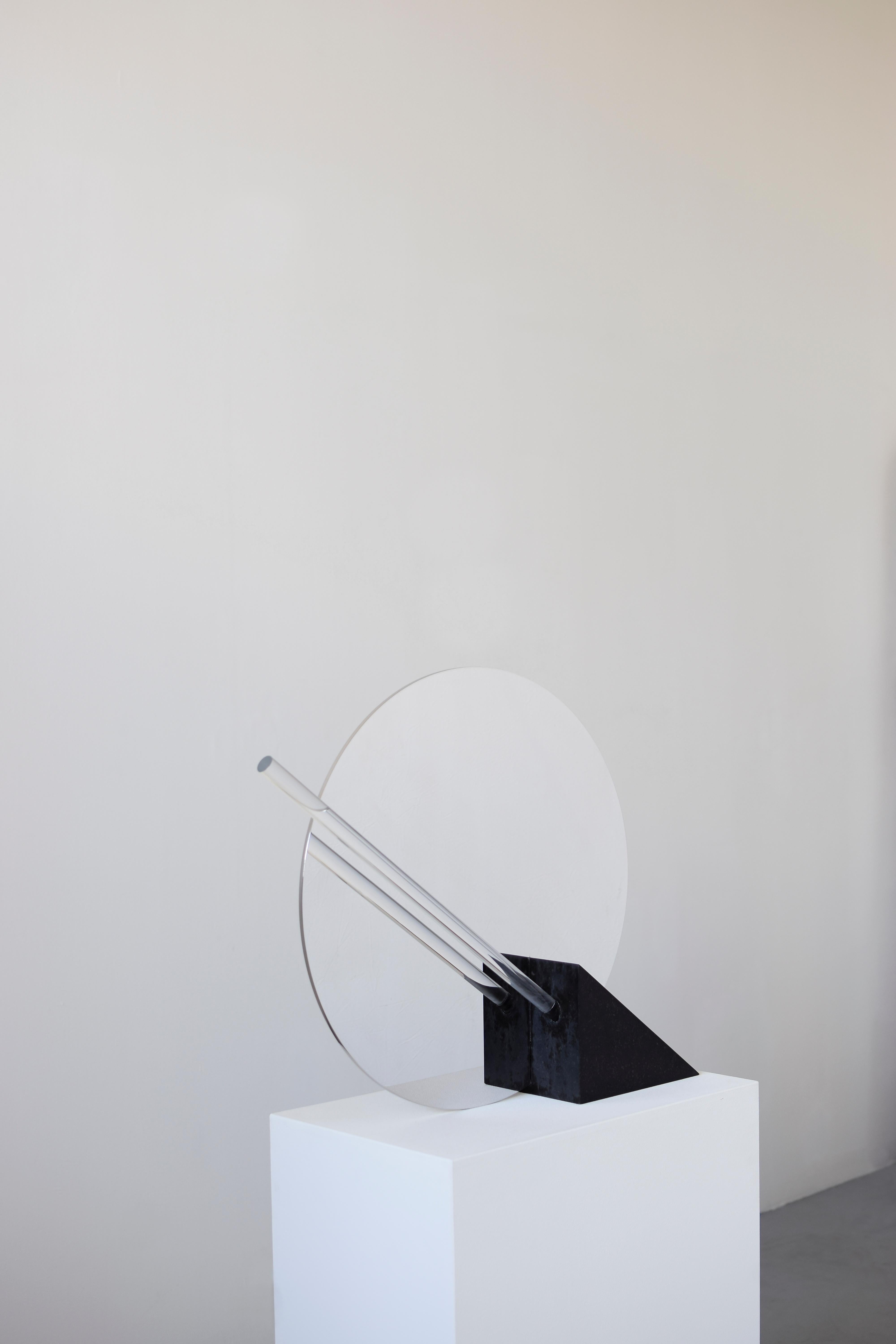 Elusive 03
A beautiful piece exploring the line between visible and invisible: half table lamp, half mirror, half sculpture.
By Maximilian Michaelis.

Belgium bluestone, polished stainless steel, acrylic glass, Led
Measure: 50 x 70 x 14 cm.