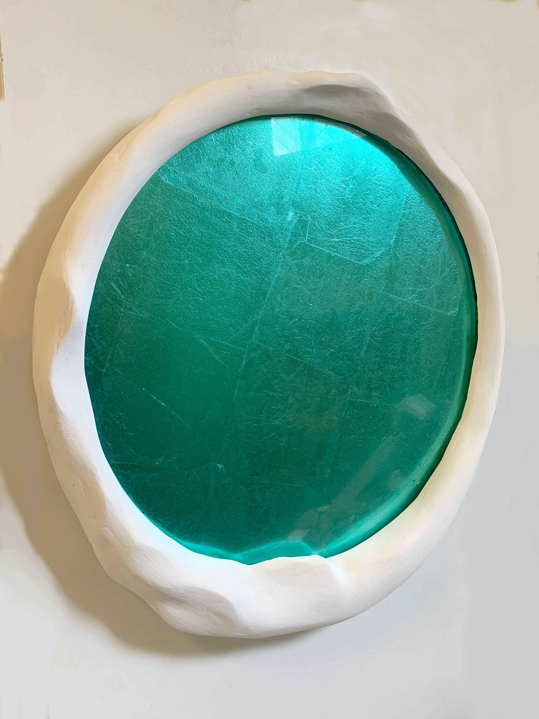 This is a custom sculptural mirror frame in white plaster and hyrdostone with interior armature, featuring japanese dyed blue leaf verre eglomise glass panel. This piece is 17.5 W x 18.5 H x 1.5 Deep inches. Upon request, this sculptural frame can