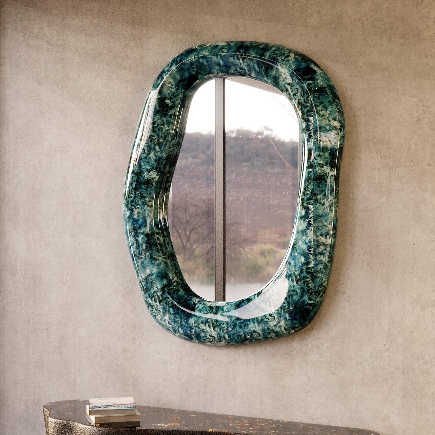 Contemporary wall mirror featuring organic shaped frame crafted of marble. Meticulously handmade by skilled artisans one piece at a time.
Pictured materials: marble finish and clear crystal mirror.
Custom sizes available upon request. 
 
We do our