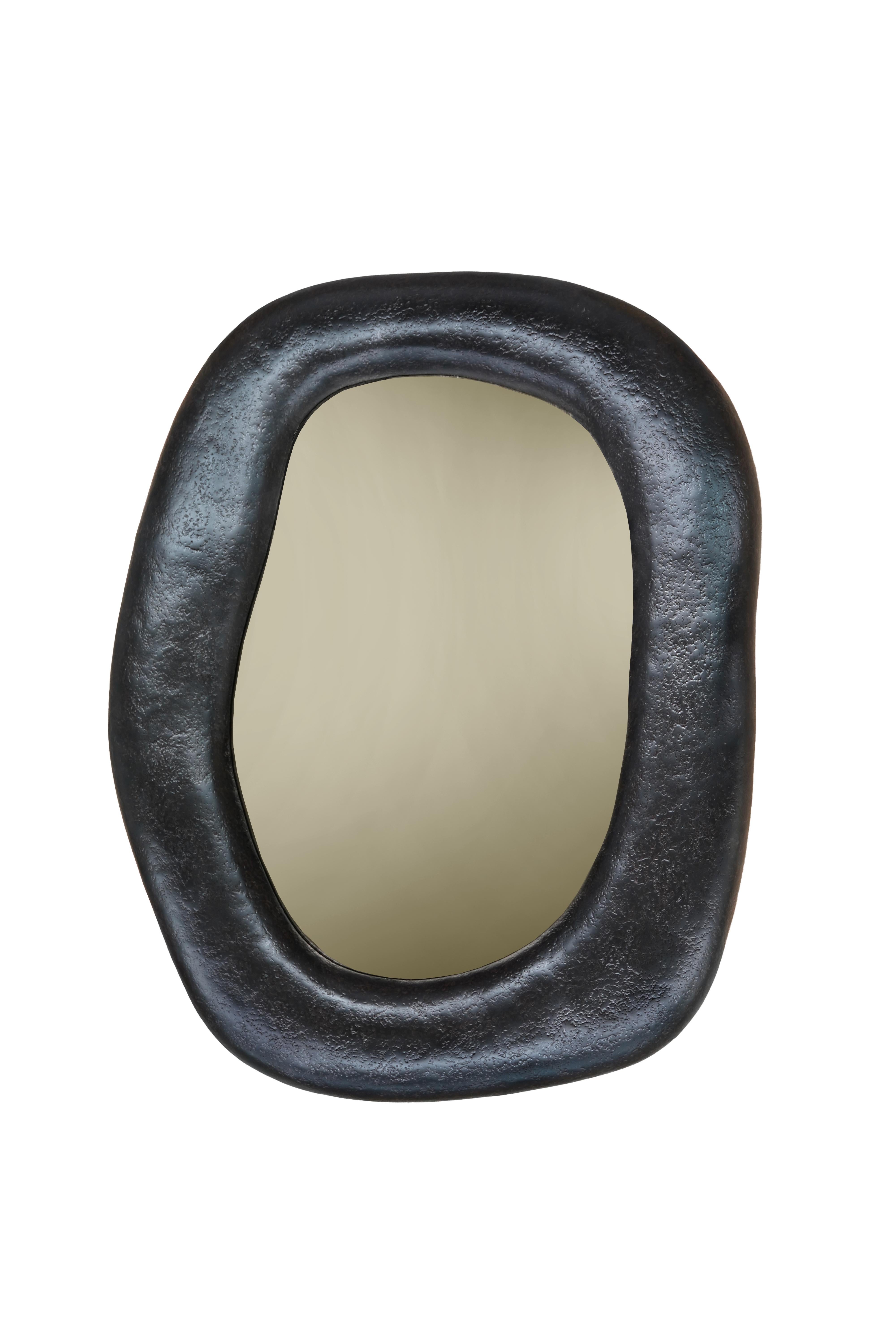 Contemporary wall mirror featuring organic shaped frame crafted of fiberglass and resin composite. Meticulously handmade by skilled artisans one piece at a time.
Pictured materials: Volcanic finish and copper bronze mirror.
Custom sizes available