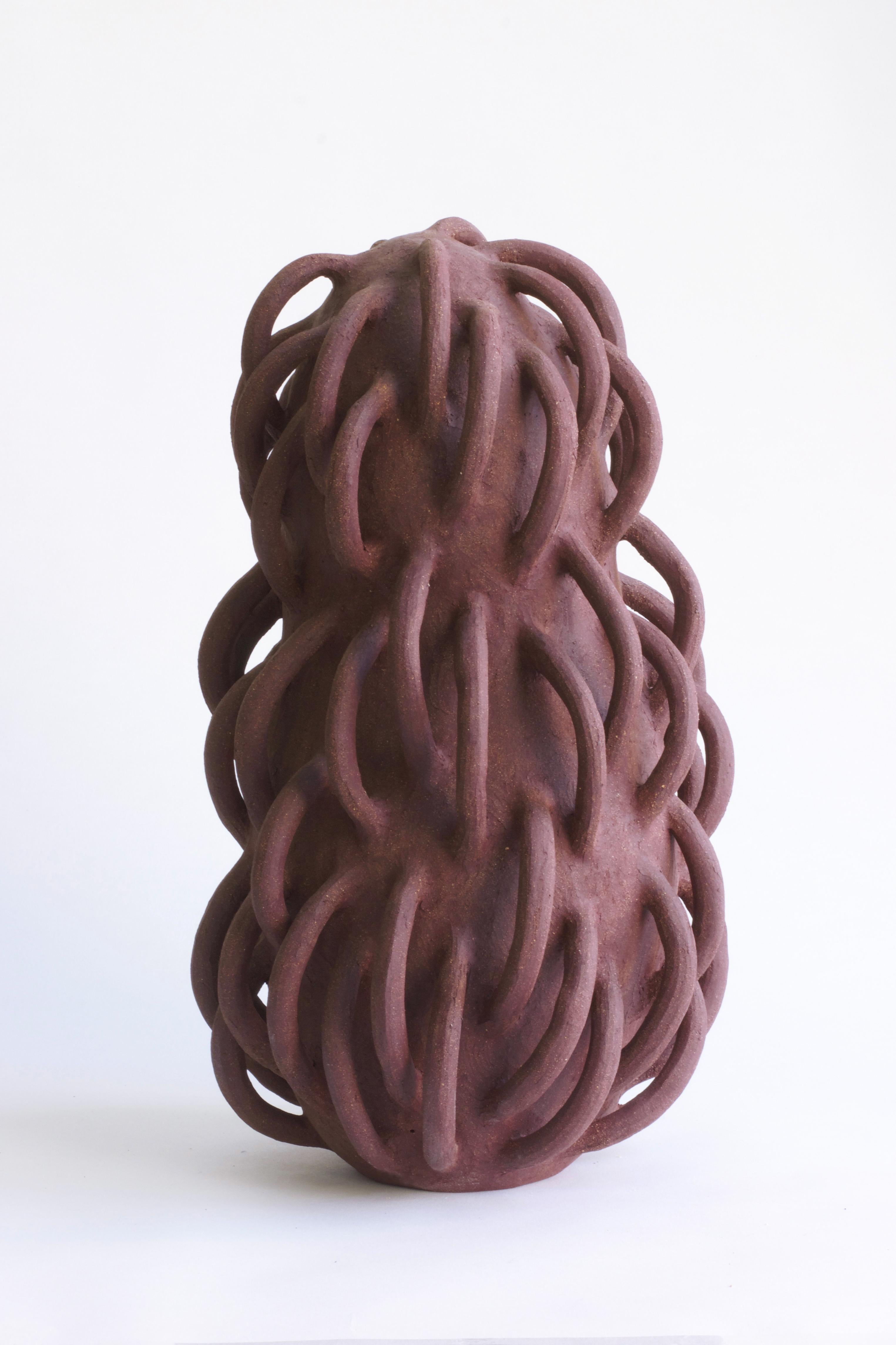 Brutalist ceramic sculpture in deep rust chamotte clay. With its slightly gritty texture and surprising tentacular appendages, this piece is sure to astonish, leaving free range to the imagination. The artist works in stoneware, shaping the clay