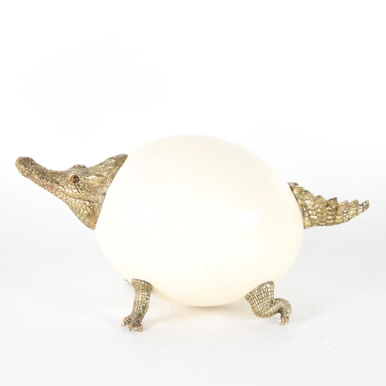 Contemporary sculpture representing a funny crocodile made of finely chiseled gilded bronze and ostrich egg. Hard stone eyes. 
High quality work, excellent condition. 