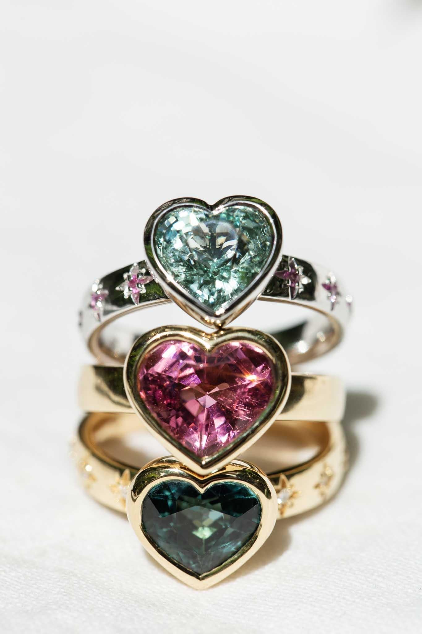 LOVE, BEGOTTEN
 
thawing out
my heart of frost
a love for you
not ever lost
 
The enchanting Cerys ring features a rapturous sea foam greenish-blue heart cut aquamarine on a shimmering pink sapphire-set band. She is an exquisite expression of love
