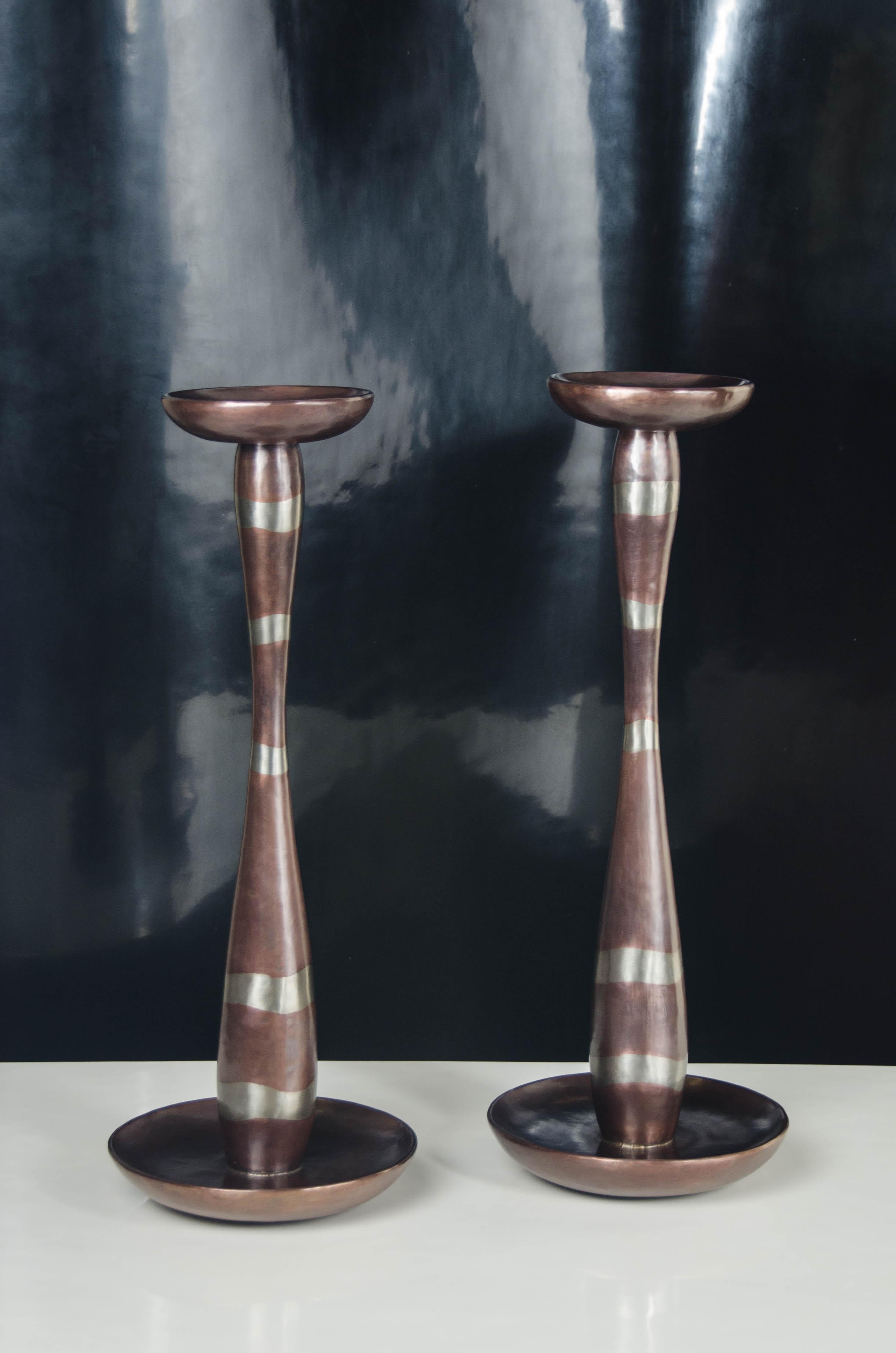 Serpentine Candlestand
Copper
White Bronze
Hand Repoussé
Limited Edition
Each piece is individually crafted and is unique.

Repoussé is the traditional art of hand-hammering decorative relief onto sheet metal. The technique originated around 800 BC