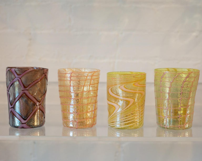 A contemporary set of 12 Murano hand blown tumblers by a Venetian artisan. Each glass is paper thin and extremely light. Made in Murano, no two glasses are ever the same. They are true jewelry for the table.