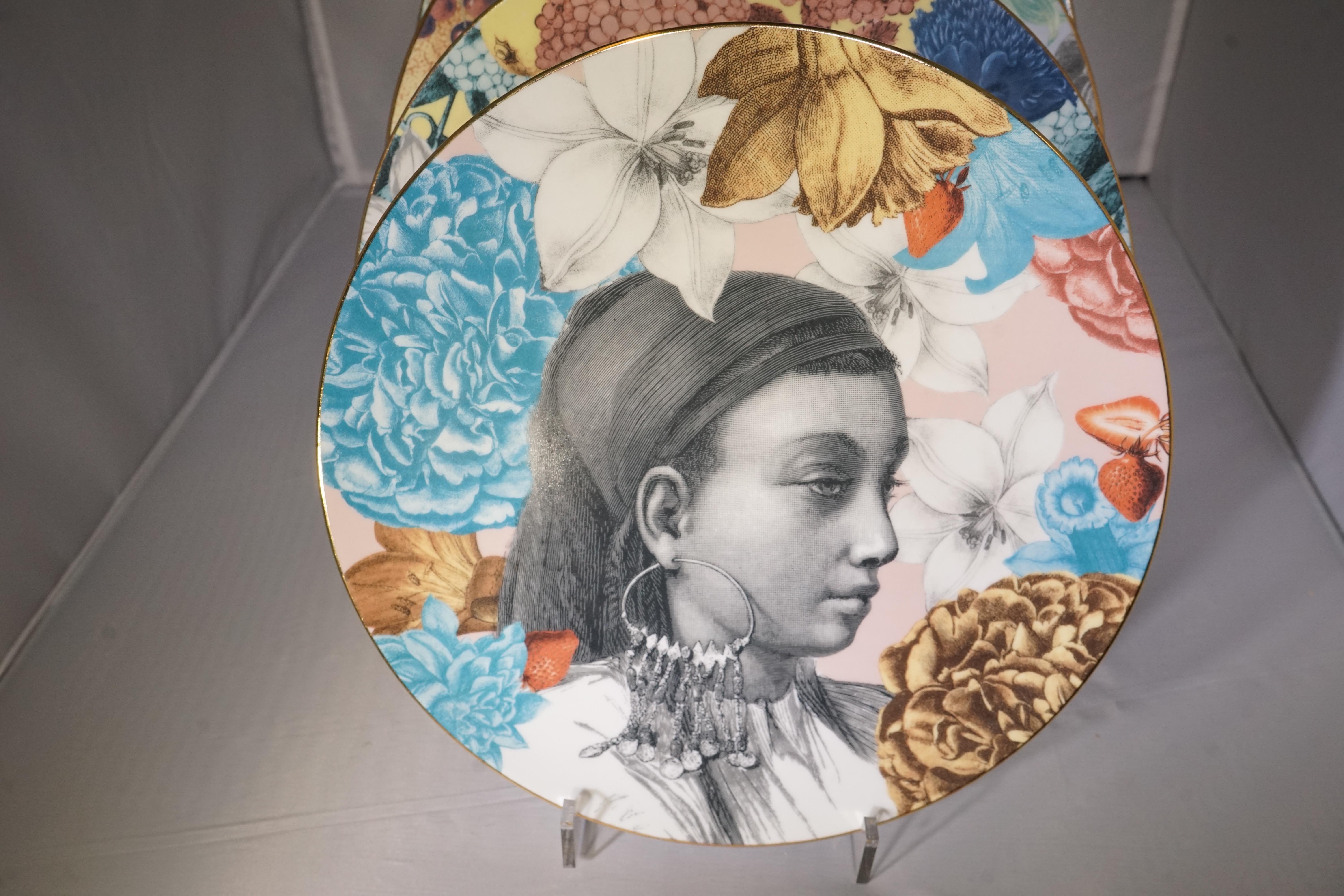Contemporary set of 12 porcelain dinner plates featuring multi-color floral designs and black and white illustrated portraits from the 