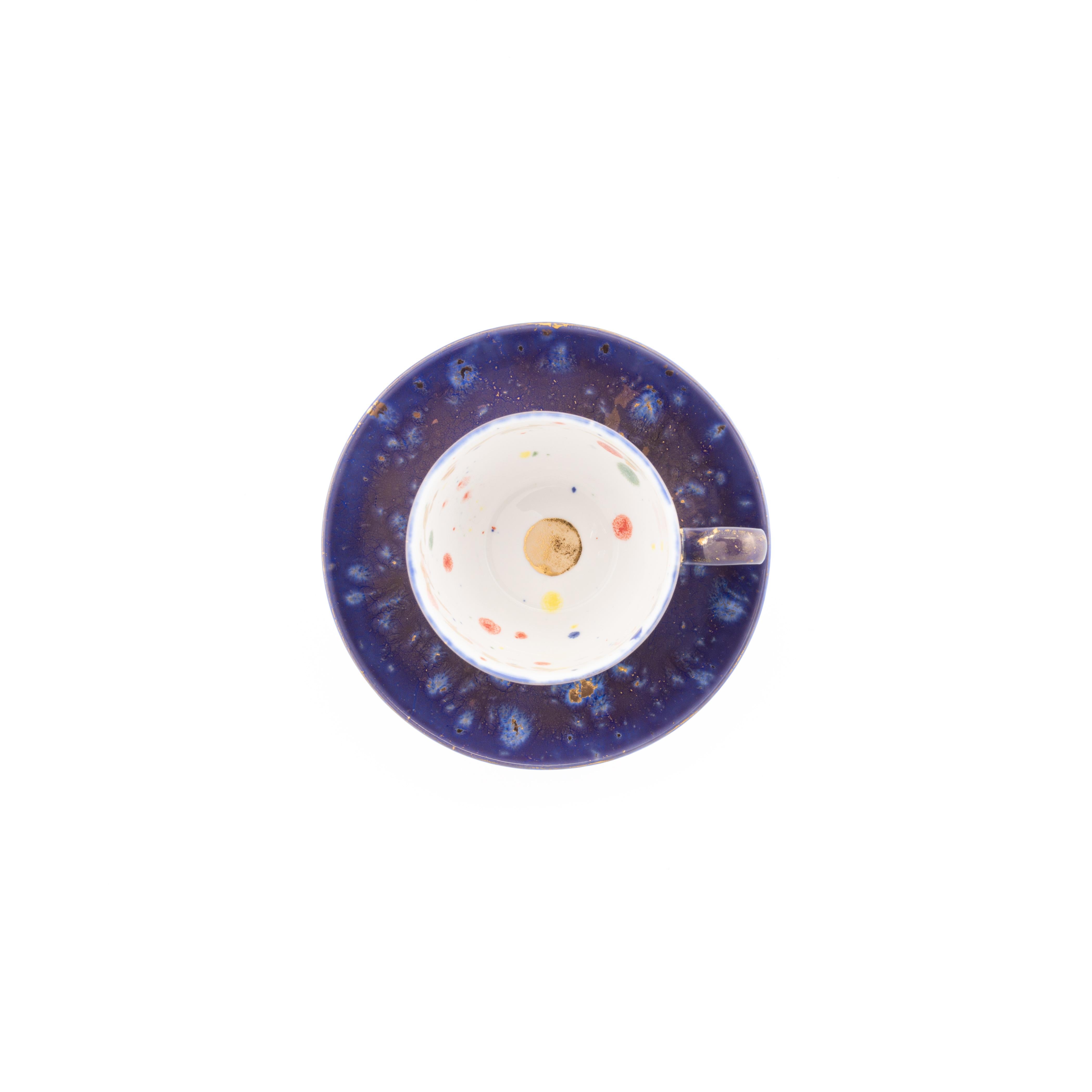 Handcrafted in Italy from the finest porcelain, this Apollo Bianco Coffee Cup & Saucer has a deep blue décor on the outside enriched by golden nuggets, like a starry night; the inside is painted in white enamel surrounded by a playful golden festoon