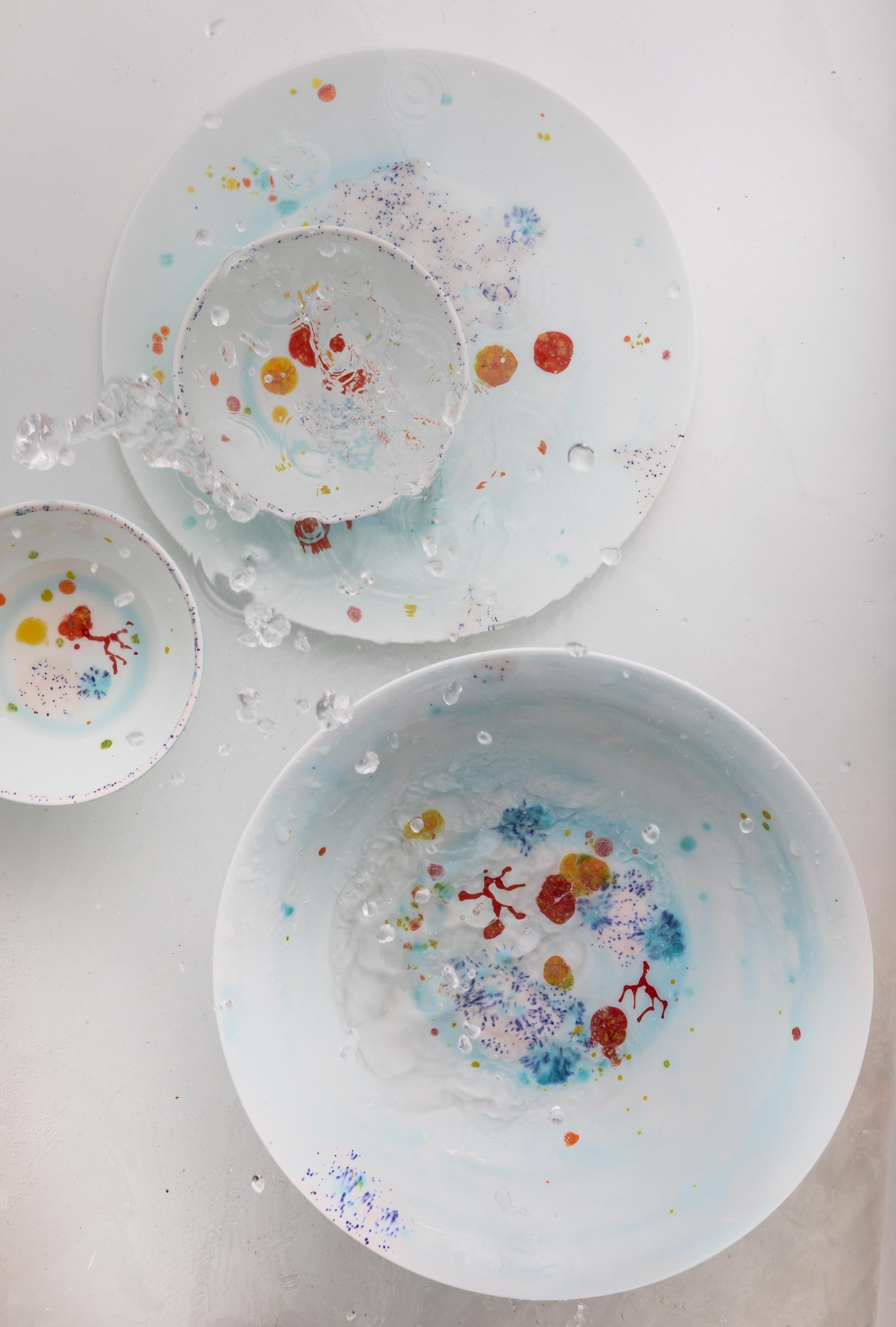 Handcrafted in Italy from the finest porcelain, these blue seabed dinner coupe plates have corals lying on a bright bottom surrounded by mysterious multicolored gems floating amid brushes of light pink sand sprinkled with black dots.

Set of 2 blue